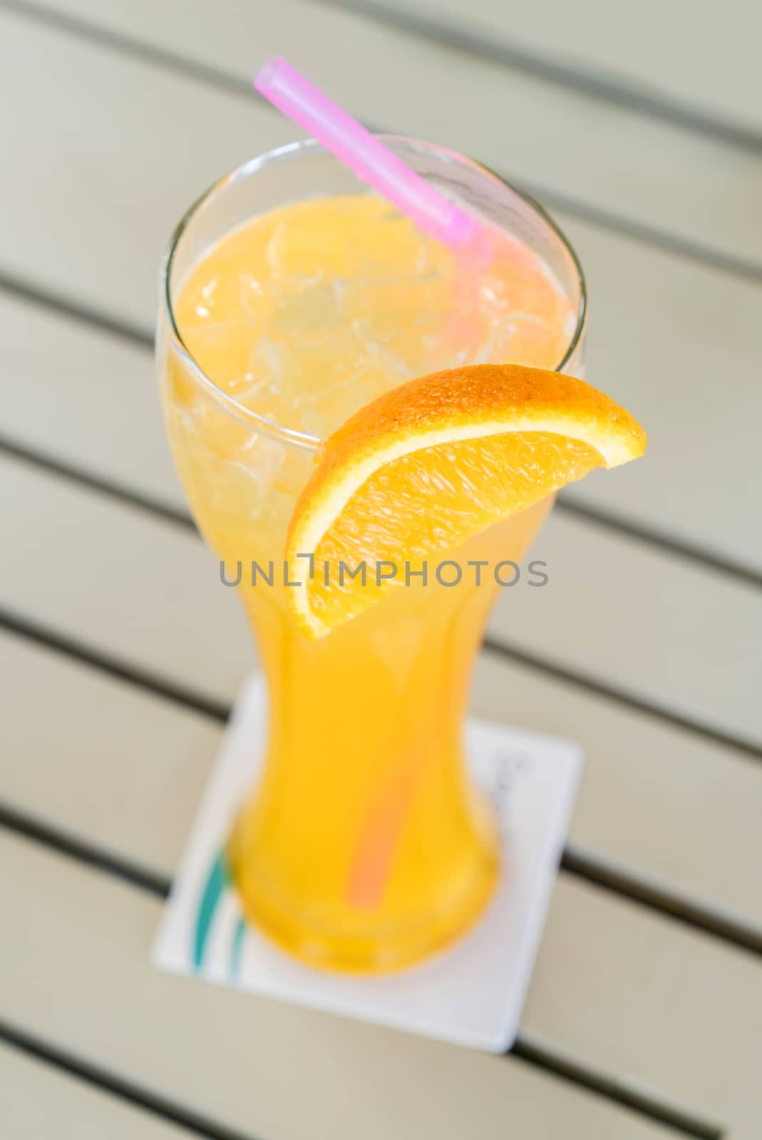 Orange juice from fresh orange in glass