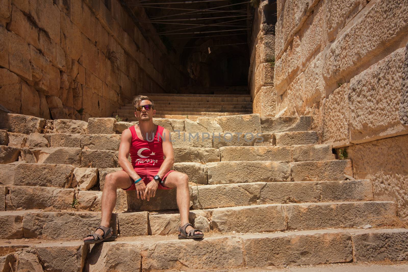 Young man at theatre in Myra ancient city of Antalya in Turkey.