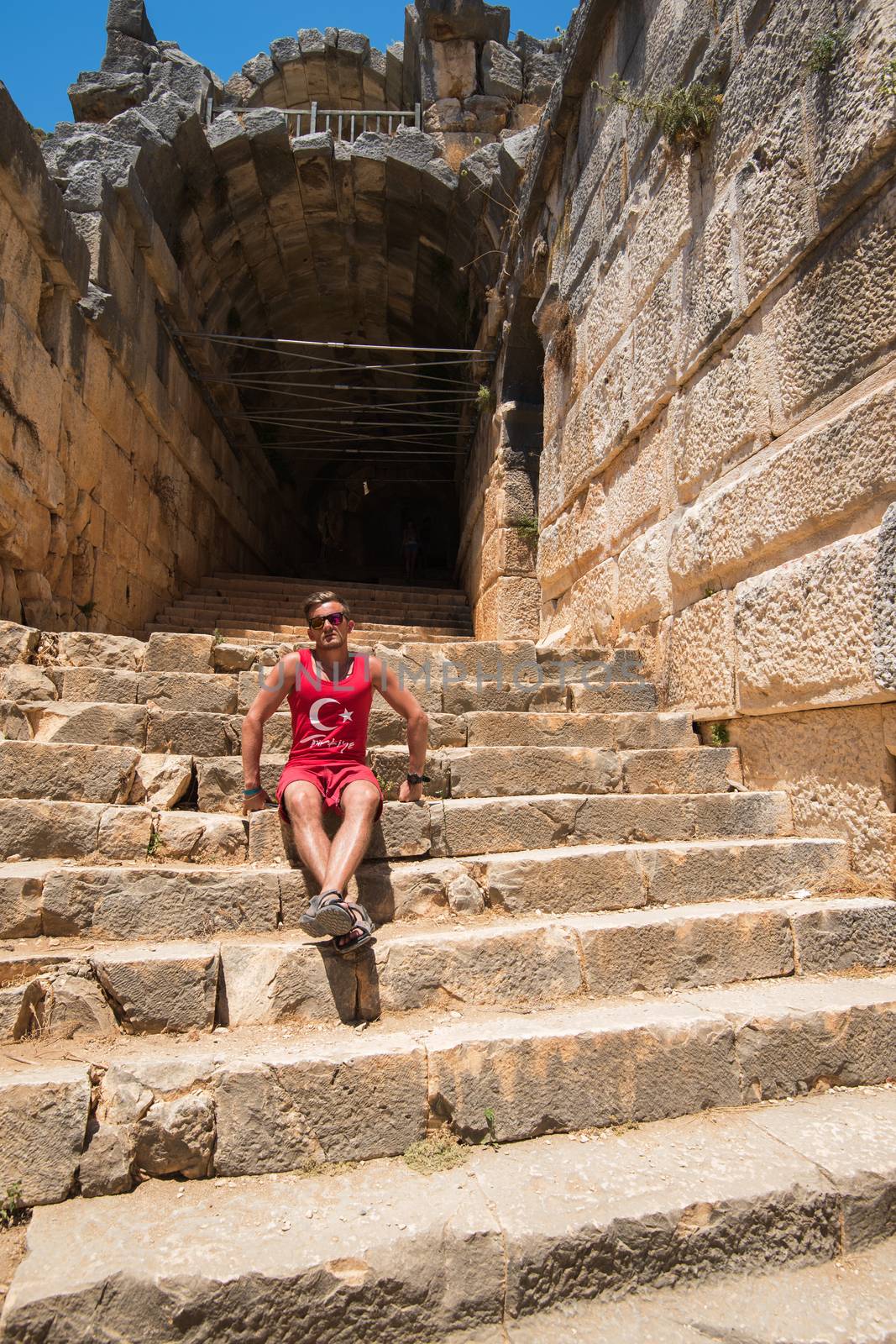 Young man at theatre in Myra ancient city of Antalya in Turkey.