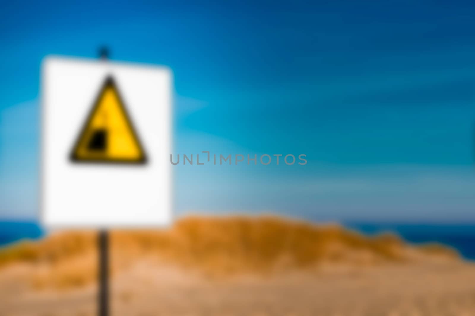 Beach alert sign - soft lens bokeh image. Defocused background