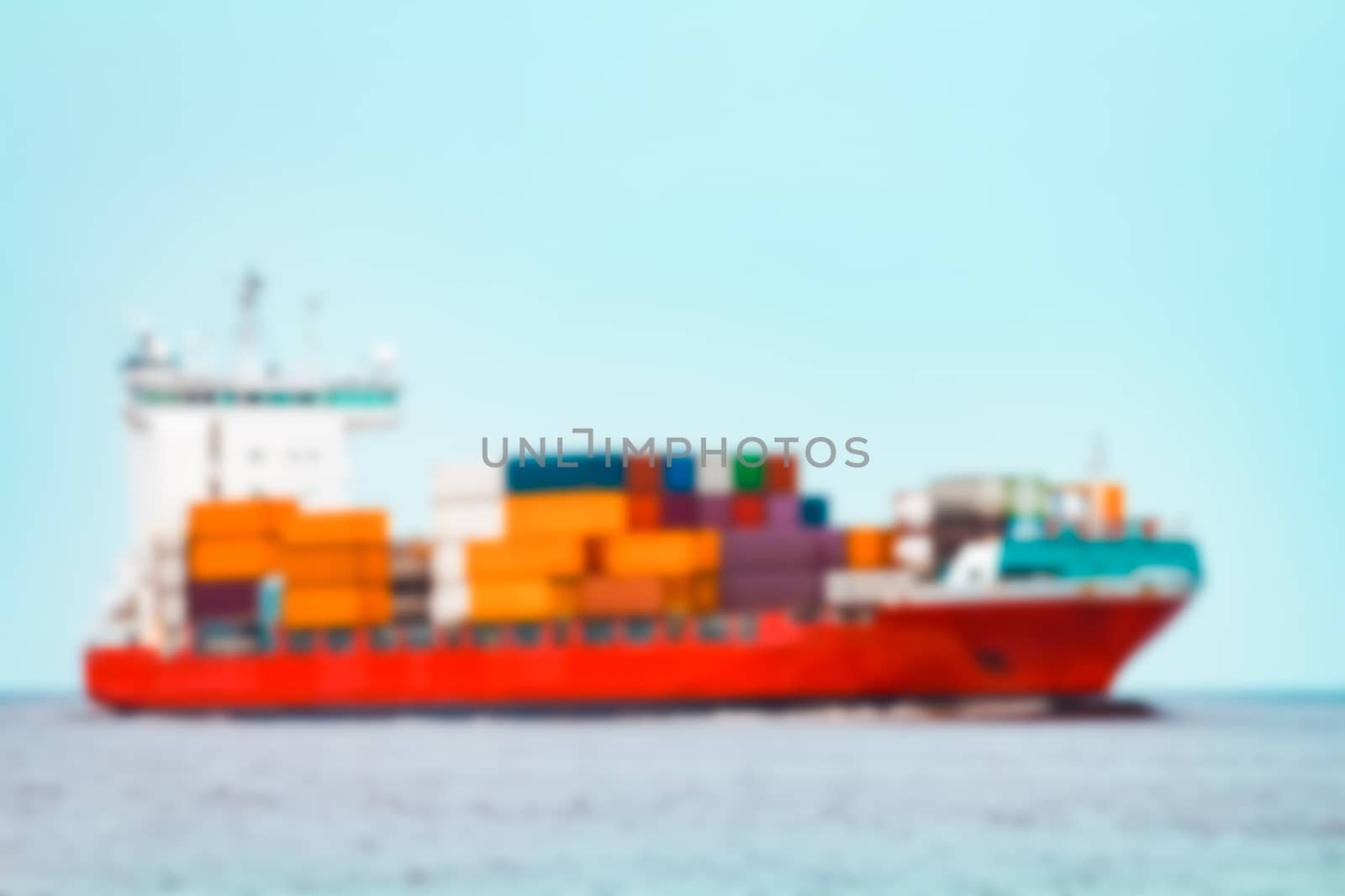 Red cargo ship - soft lens bokeh image. Defocused background