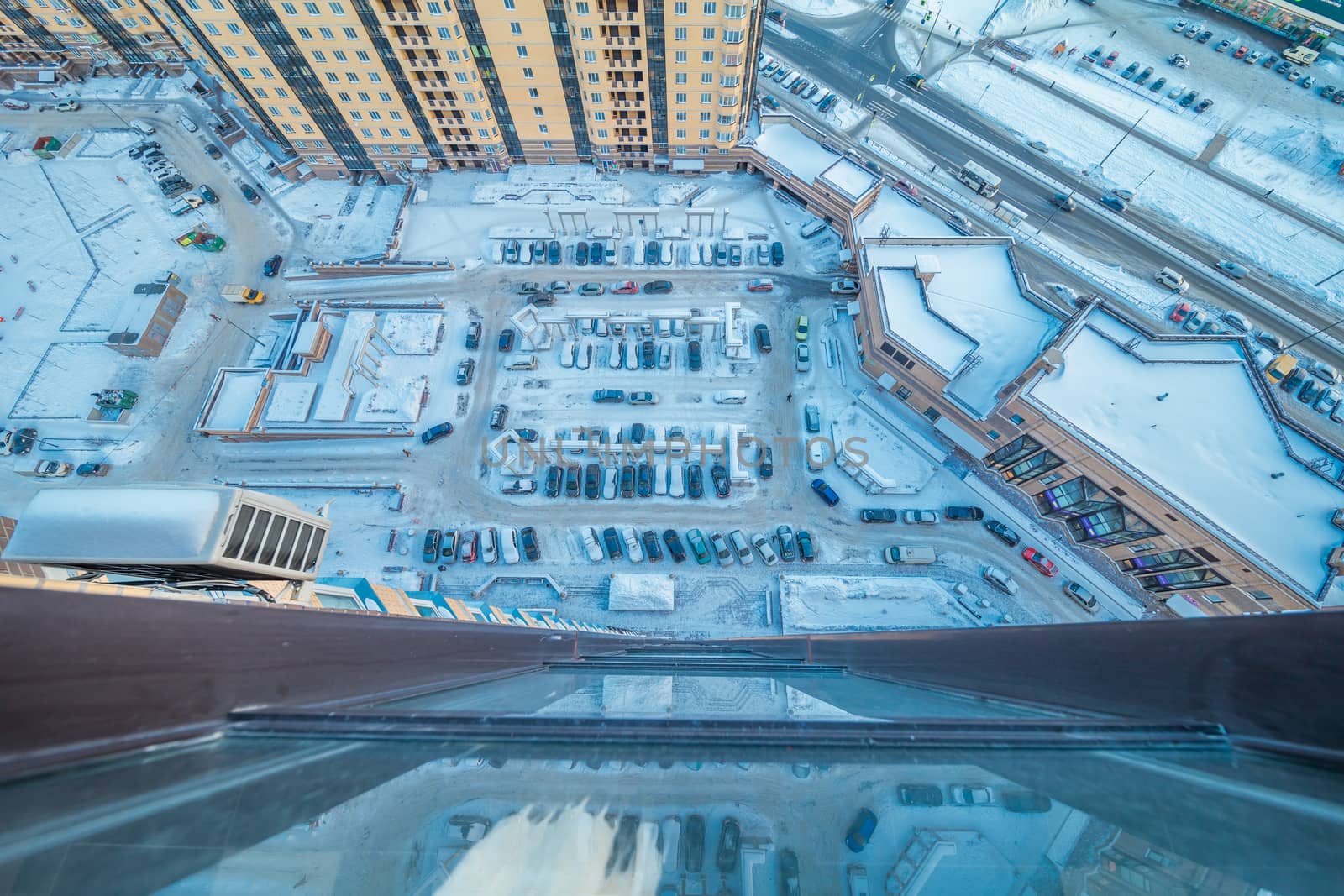 View down from skyscraper on parking lot with cars