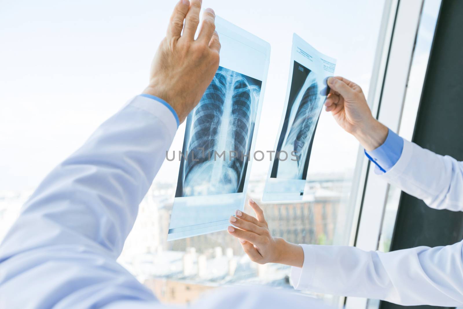 Group of doctors look and discuss x-ray in a clinic or hospital