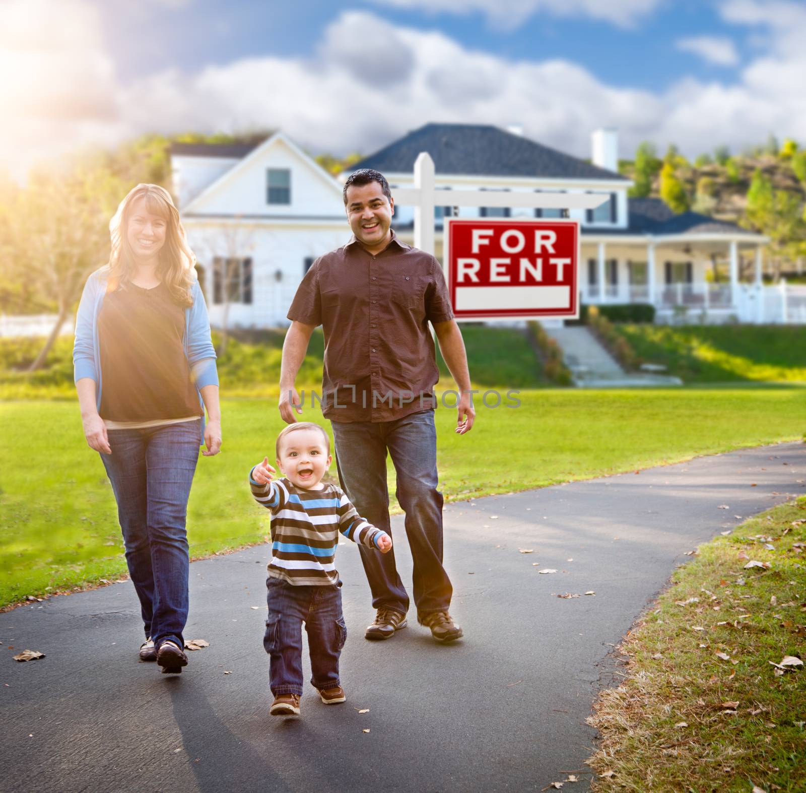 Happy Mixed Race Family Walking in Front of Home and For Rent Real Estate Sign. by Feverpitched