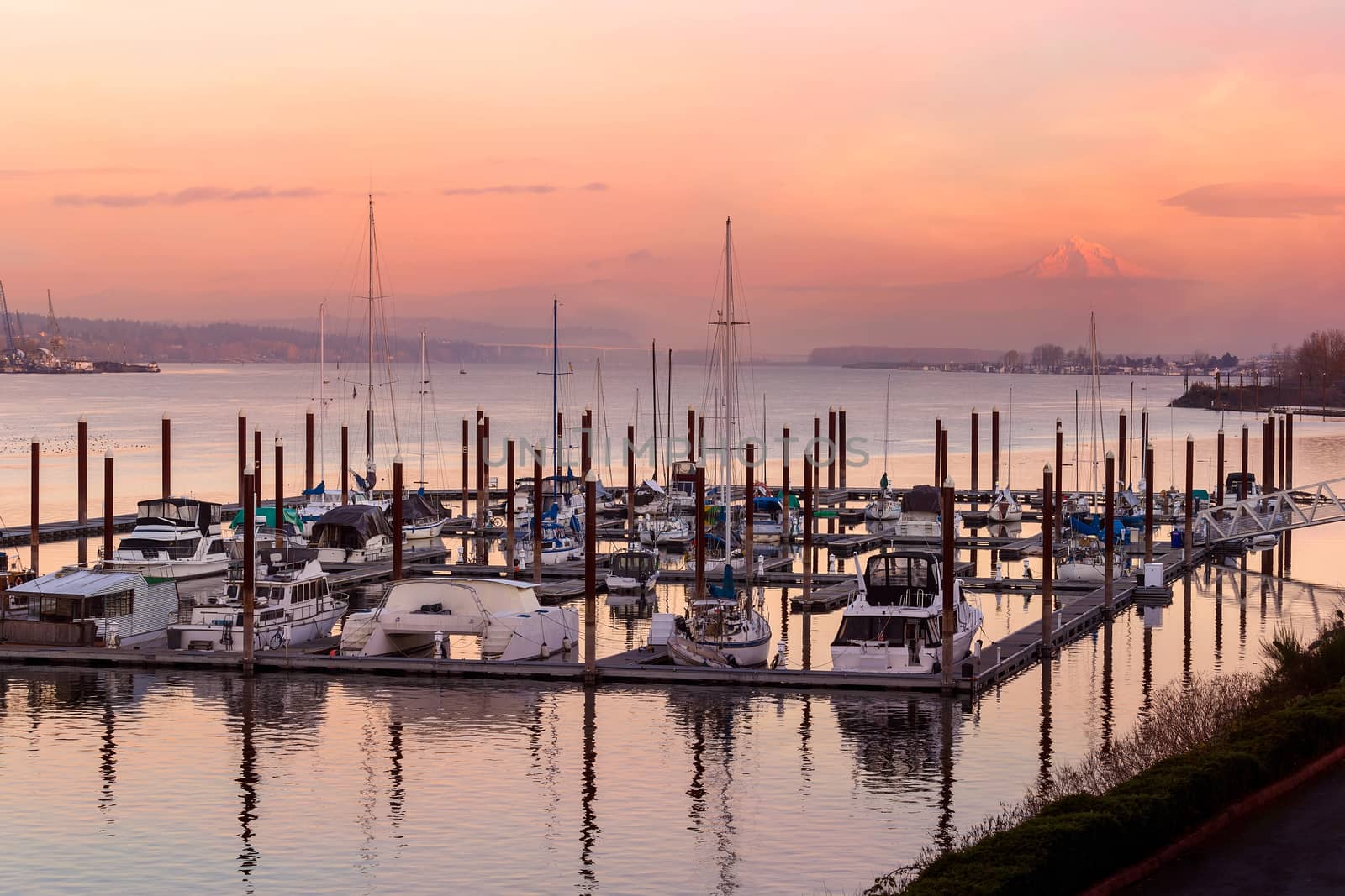 Sailboats moored at Marina along Columbia River with Mount Hood view in Oregon during sunset