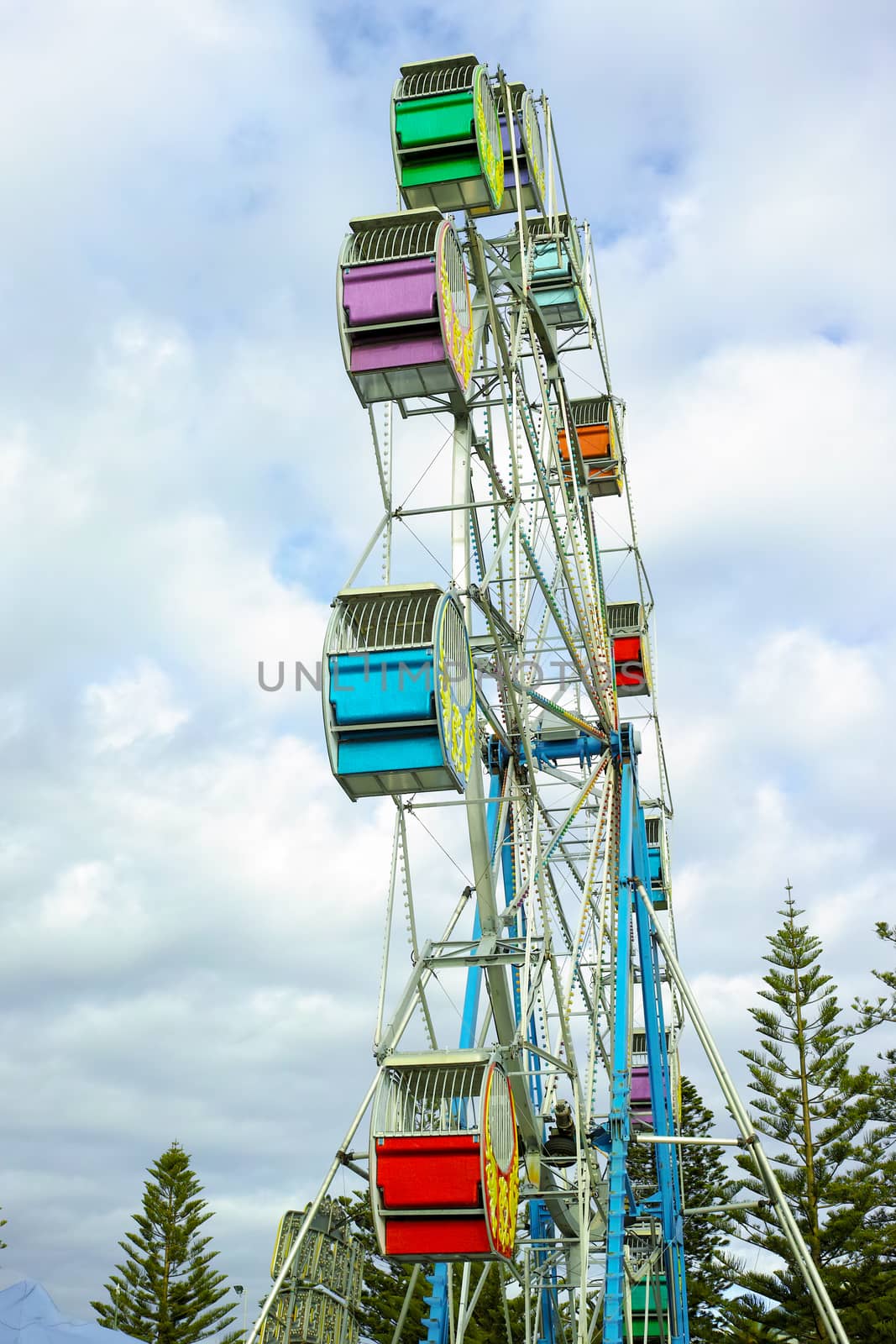 Looking up at a ferris wheel in amusement park by jaaske