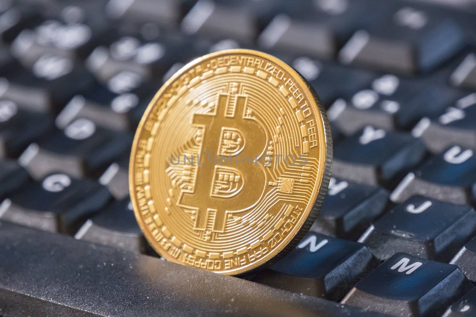 Bitcoin coin over black keyboard by max8xam