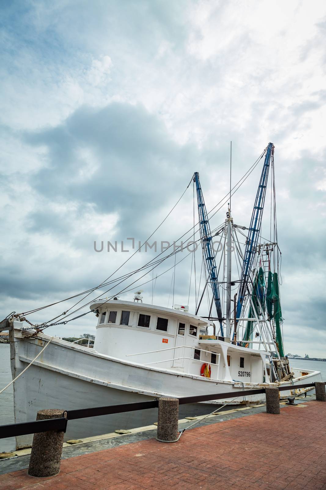 SAVANNAH, GEORGIA - MARCH 1, 2018: A shrimp boat is tied up on the River Street dock on the Savannah River.