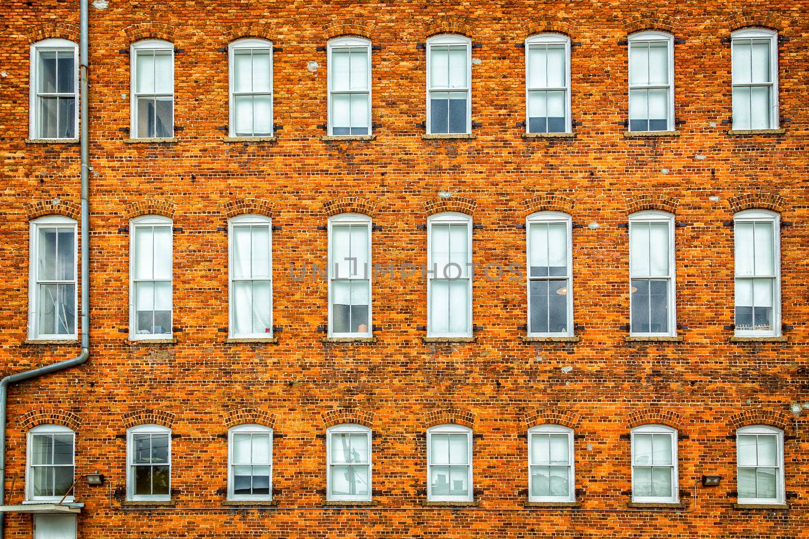 Brick wall of windows by adifferentbrian