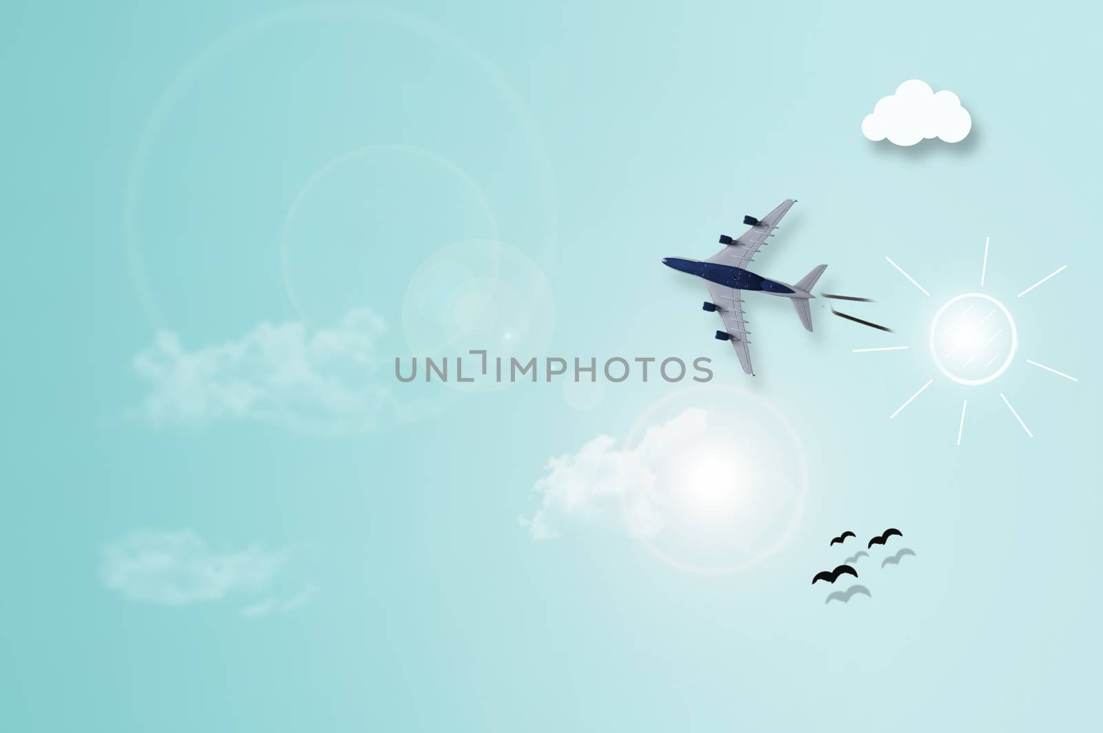 Miniature plane on sky paper background with illustration of sun, clouds and birds 