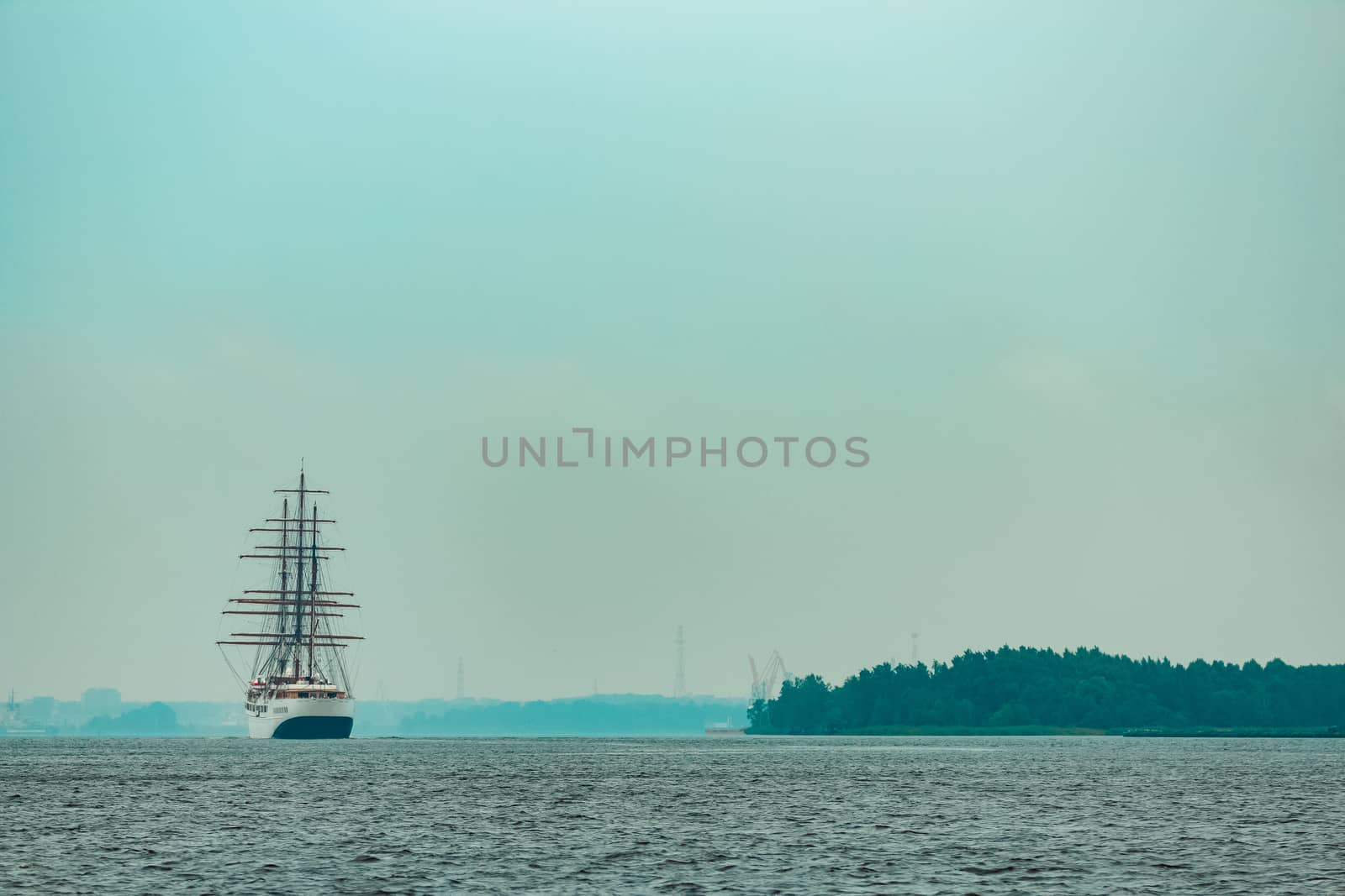 Big white sailing ship with three mast moving to the Riga port