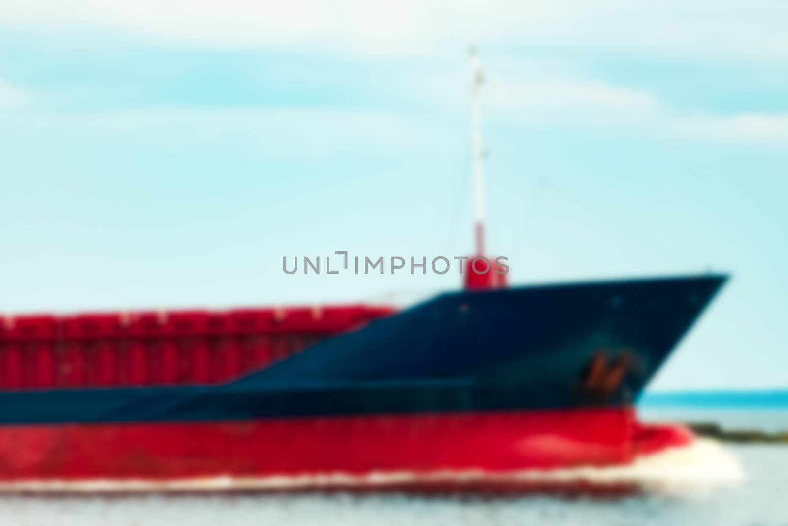 Blue cargo ship - blurred image by sengnsp