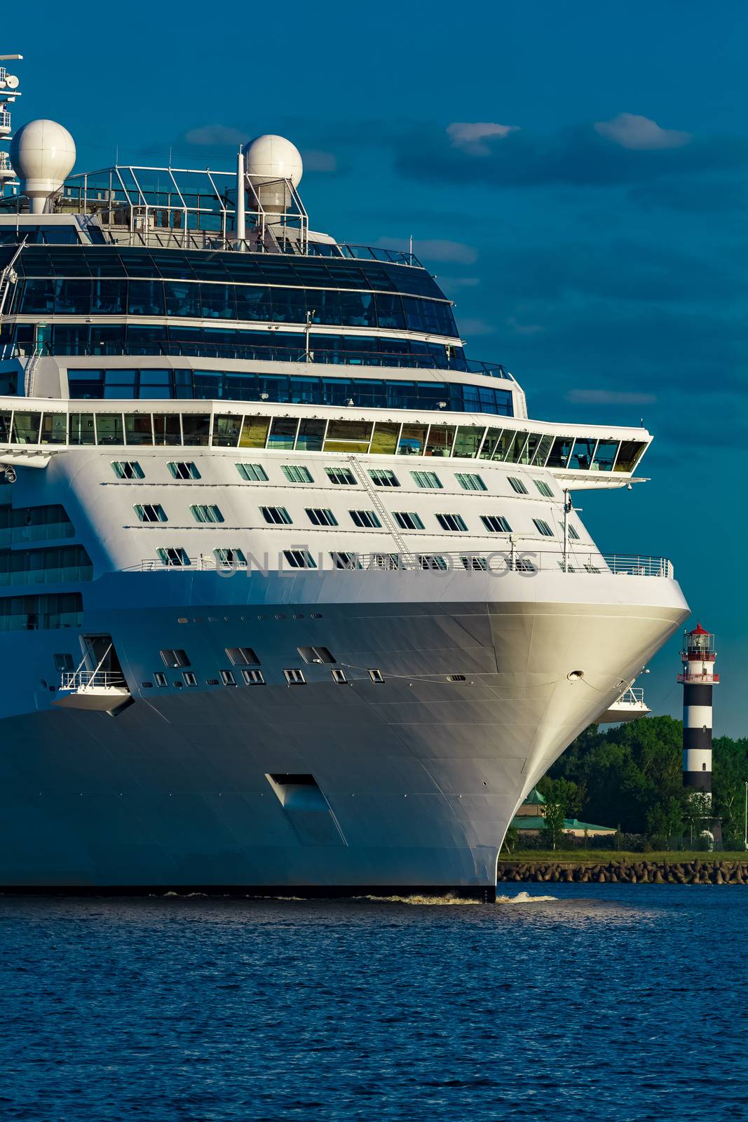 White giant brand new passenger ship moving in clear summer day