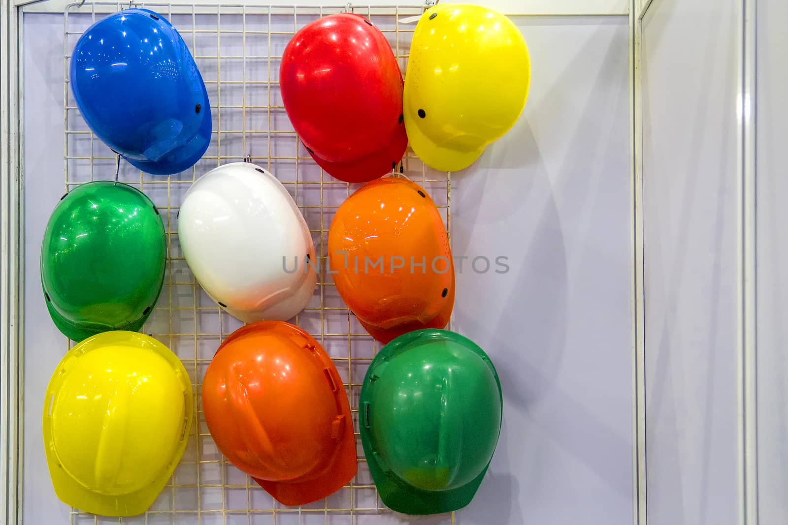 Multi-colored helmet hanging over the wall.