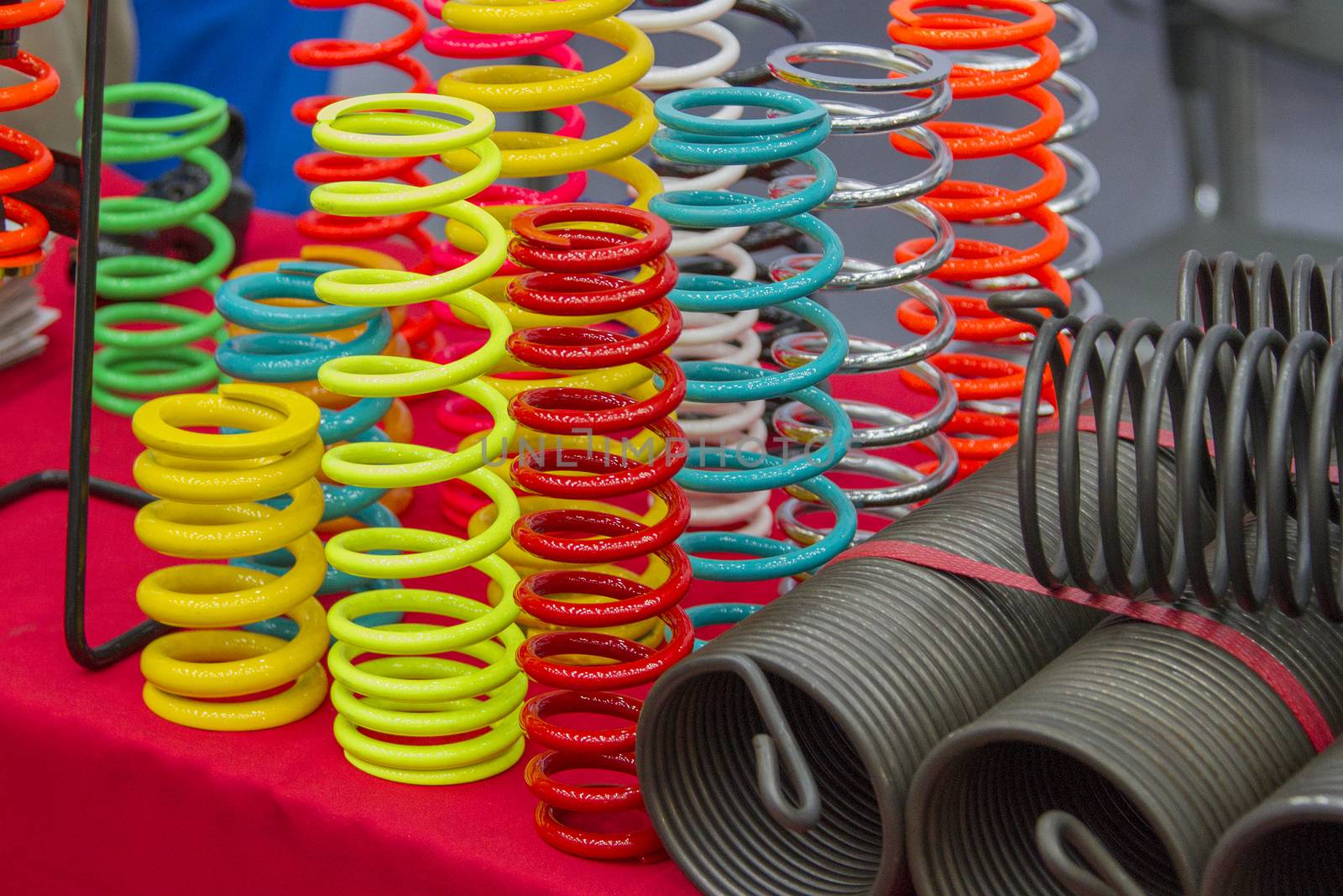 Coil springs are many colors on the red table.