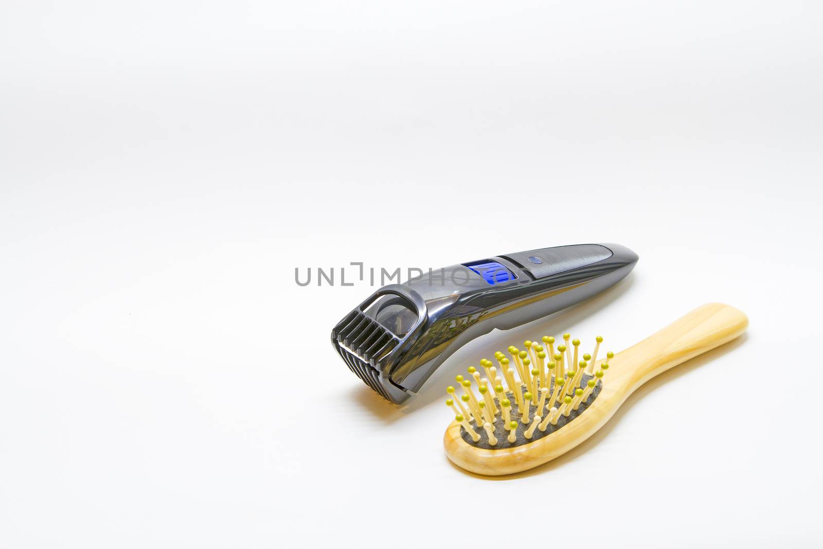 Hair brush comb with scraping hair and clipper on a white backgr by TakerWalker