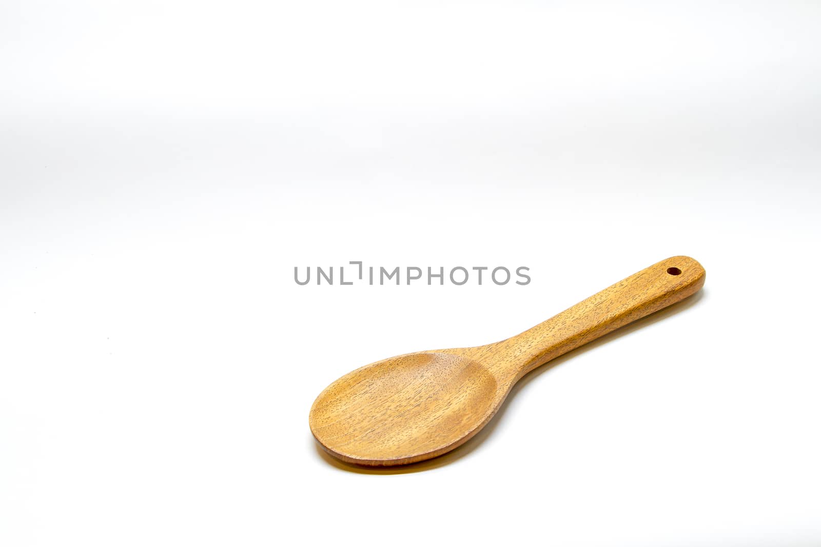 Brown wooden spoon on white background by TakerWalker