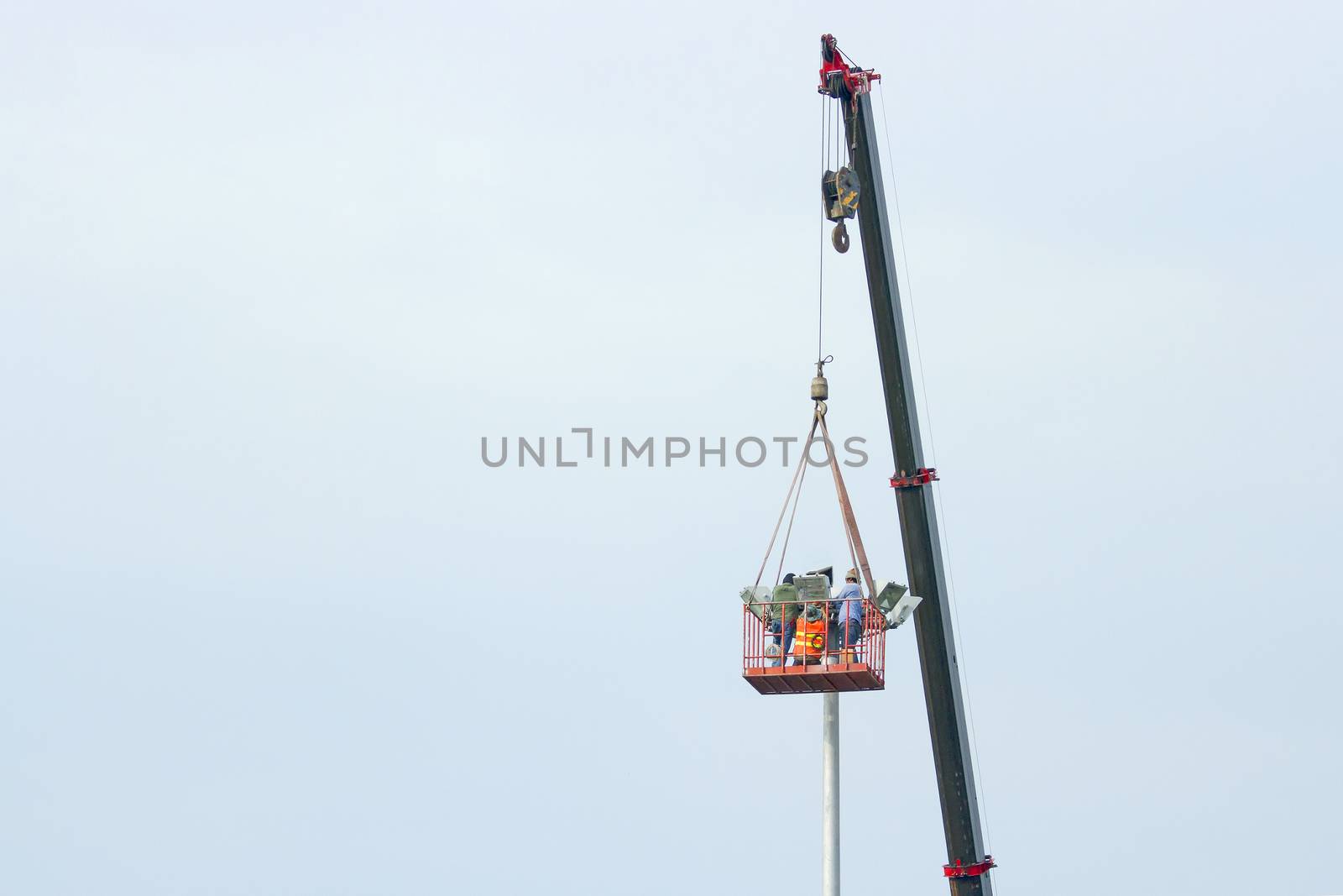 Use crane to lift the light bulbs to repair the light pole