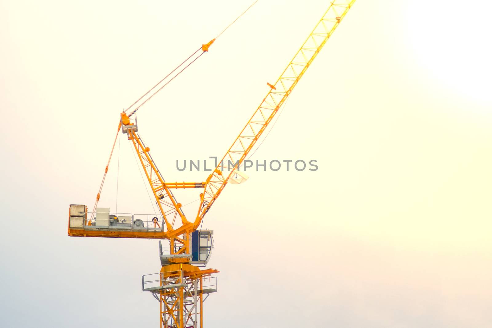 Yellow lifting crane Prepare to start In blue sky by TakerWalker