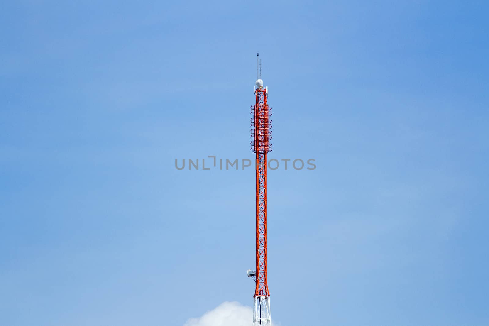 Mobile phone communication tower transmission  signal with blue sky background and antenna