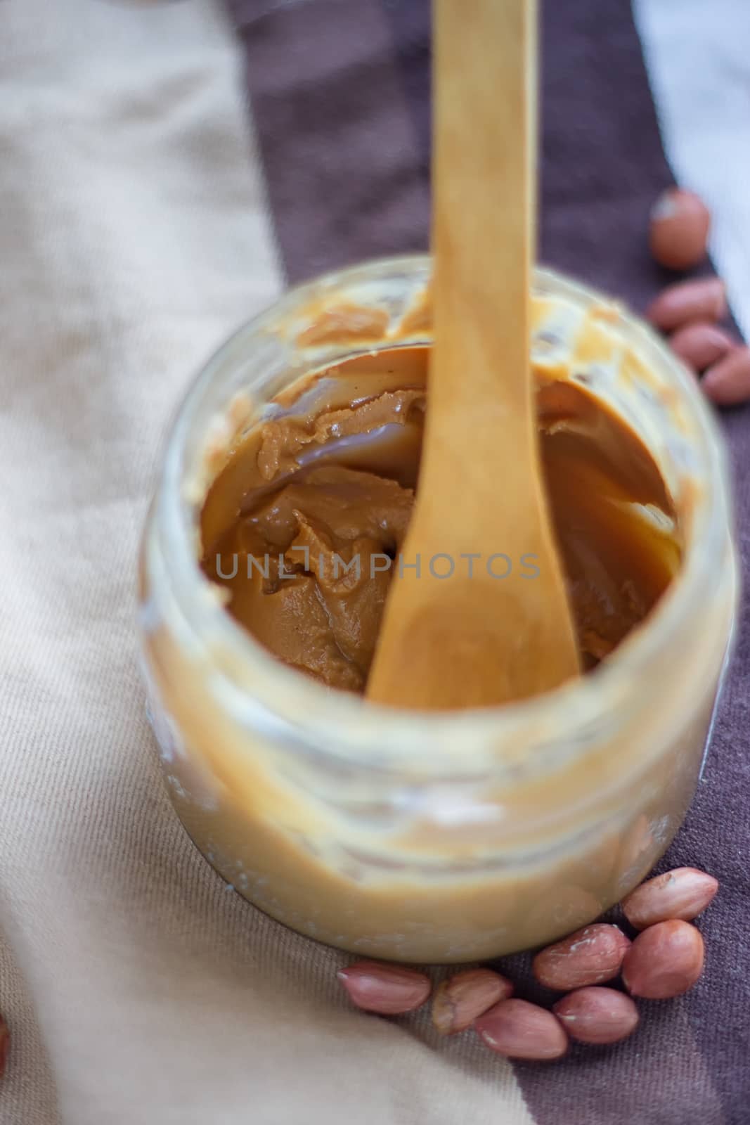 an open jar of peanut butter with spoon