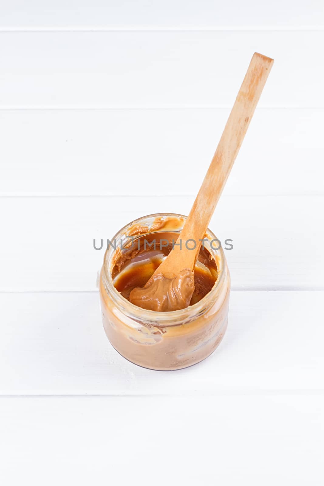 an open jar of peanut butter with spoon