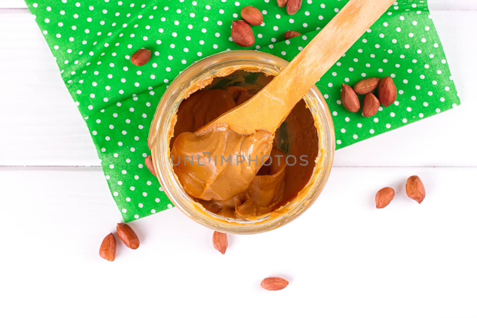 an open jar of peanut butter with spoon