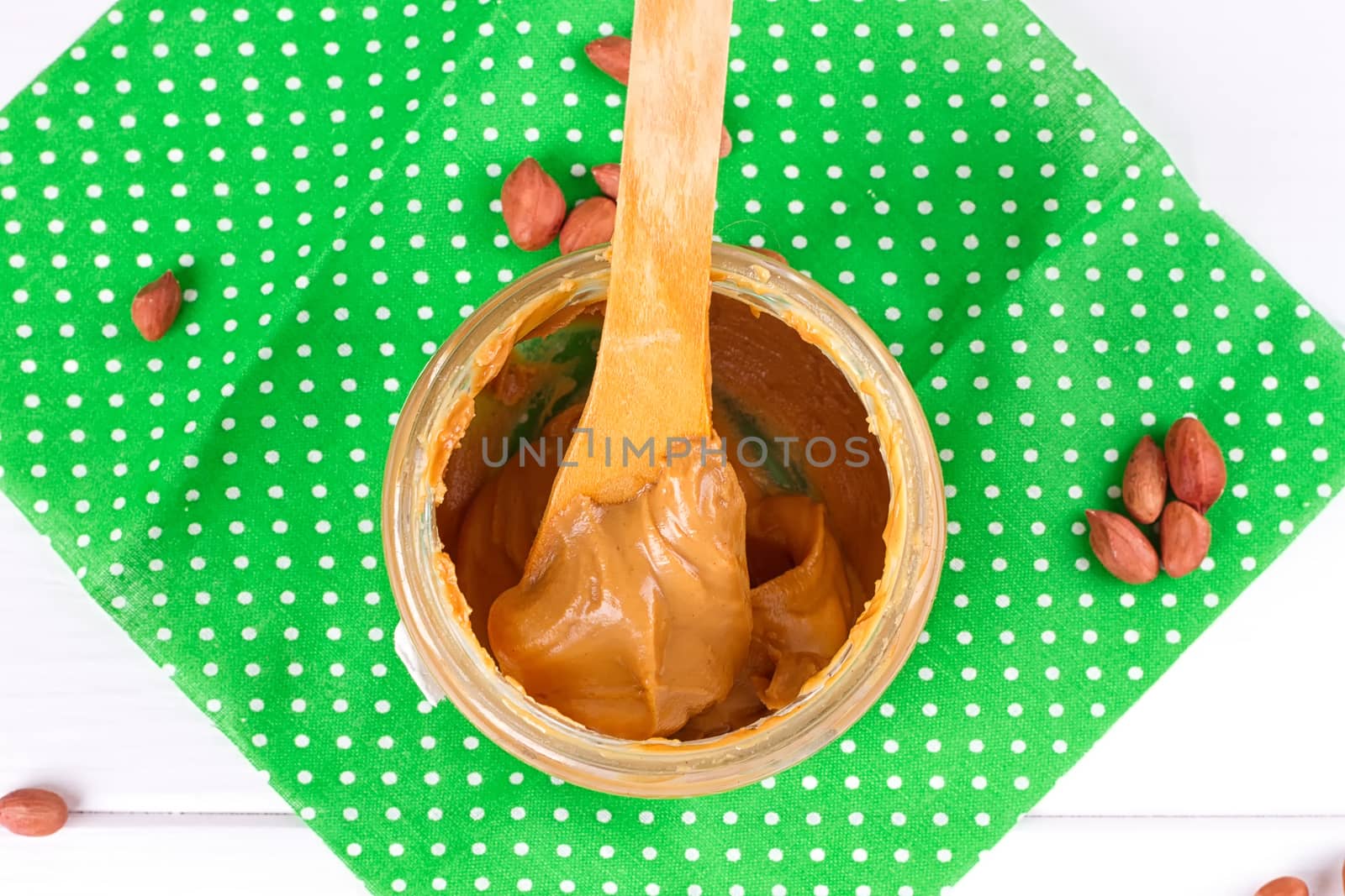 an open jar of peanut butter with spoon