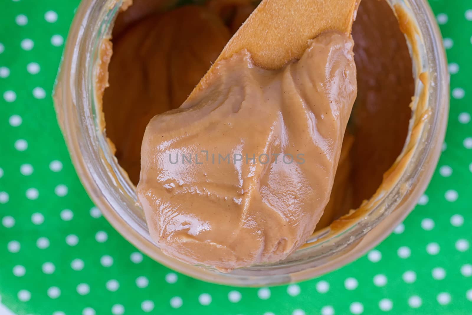 an open jar of peanut butter with spoon