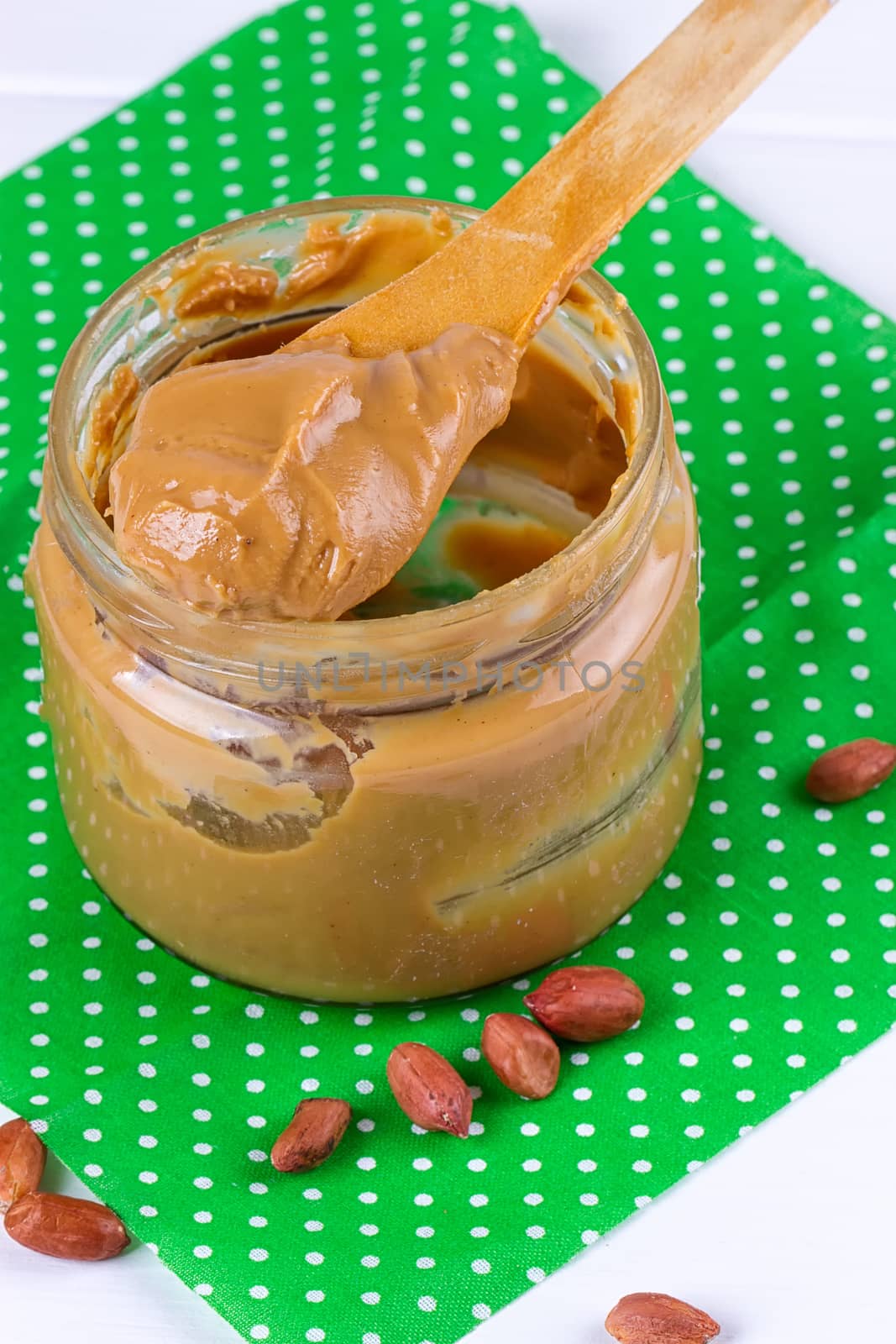 an open jar of peanut butter with spoon