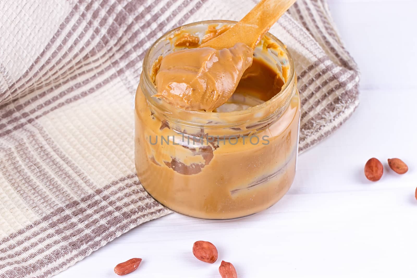 an open jar of peanut butter with spoon