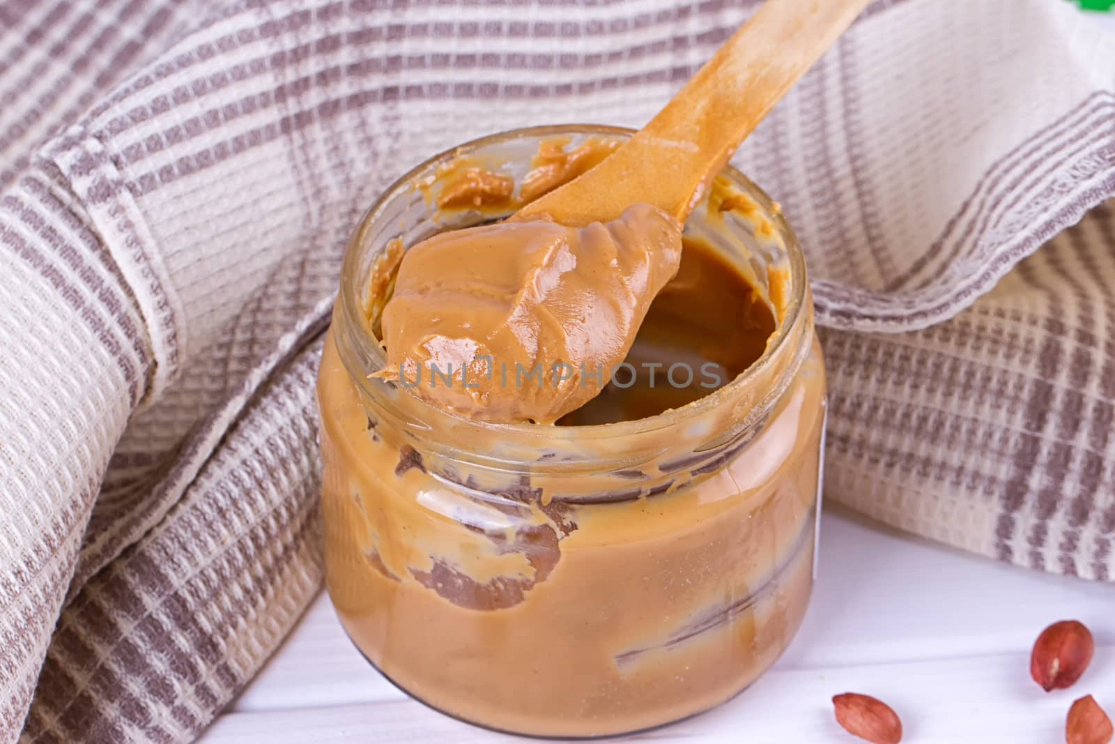 an open jar of peanut butter with spoon