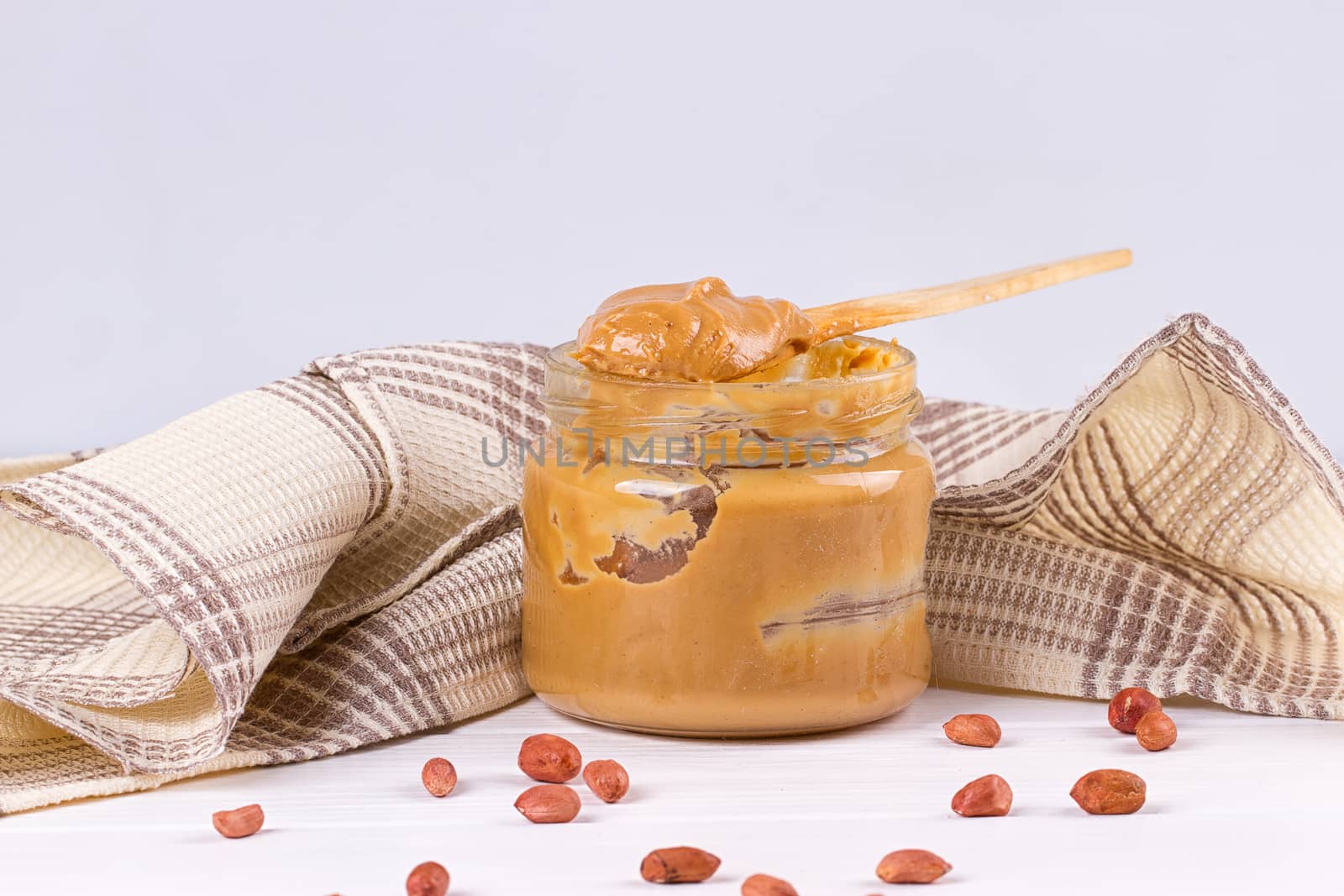 an open jar of peanut butter with spoon