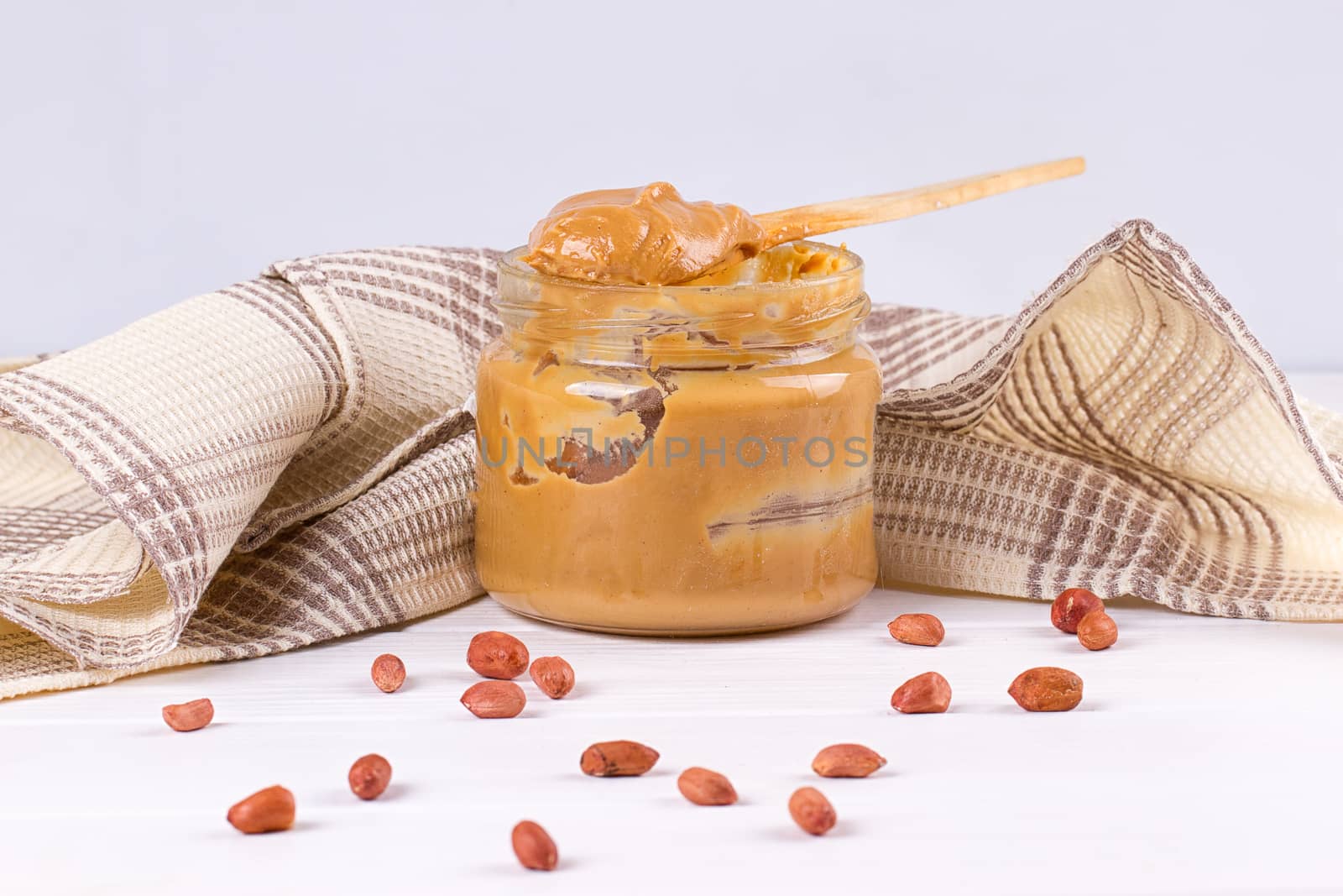 an open jar of peanut butter with spoon