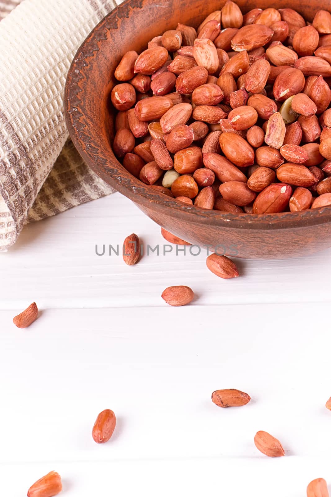 Peanuts in a brown plate. on white background