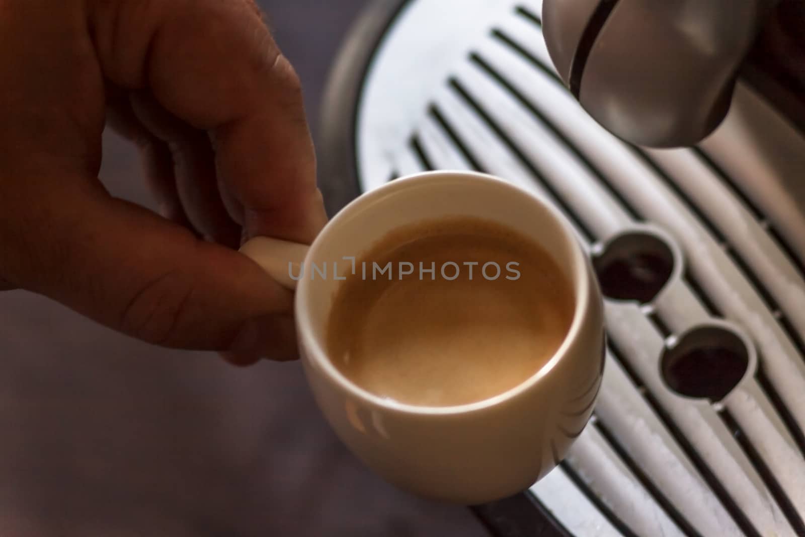 Close up view of the hand of a man working in a coffee house pre by Tanacha