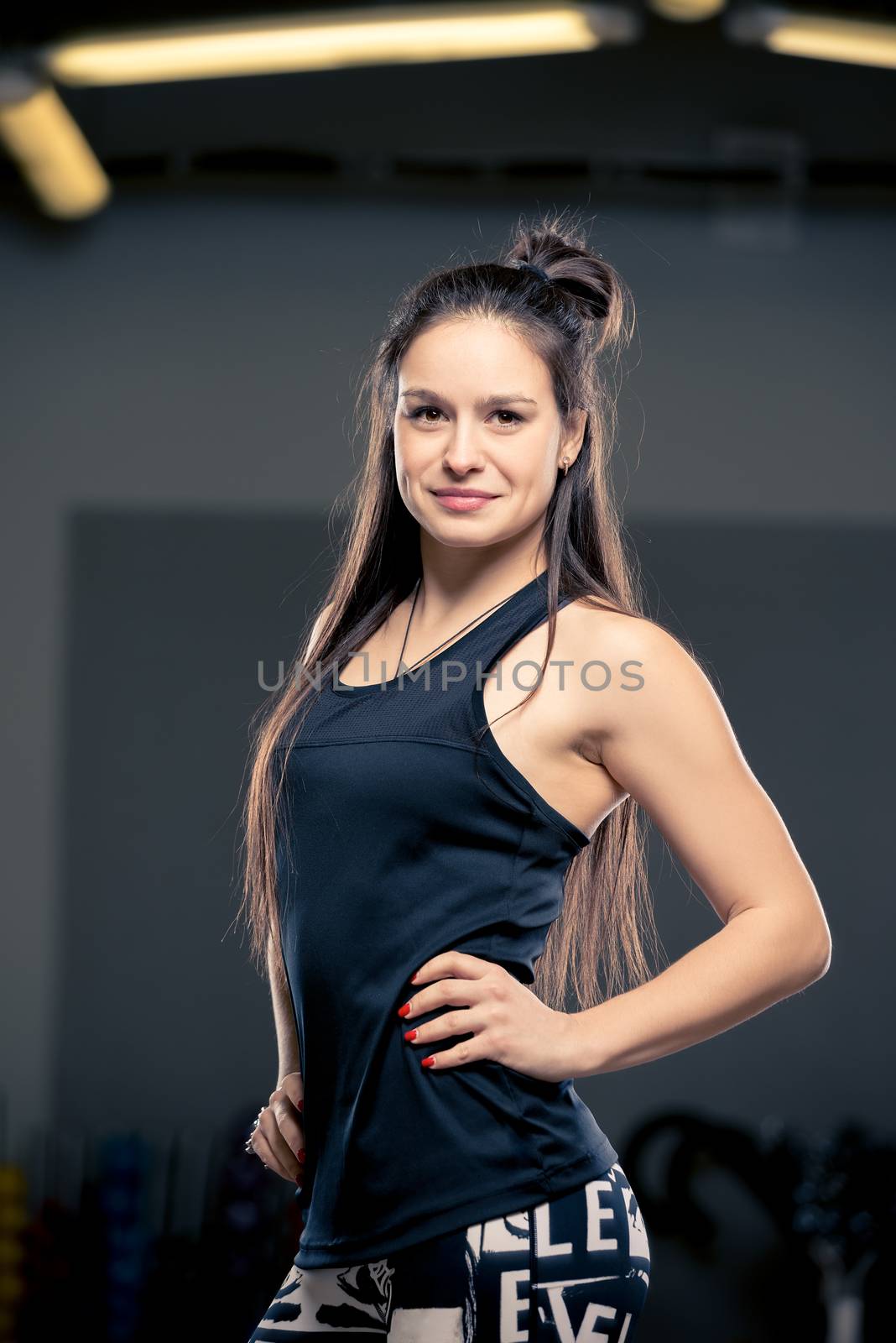 young brunette posing in sports hall, vertical portrait, women