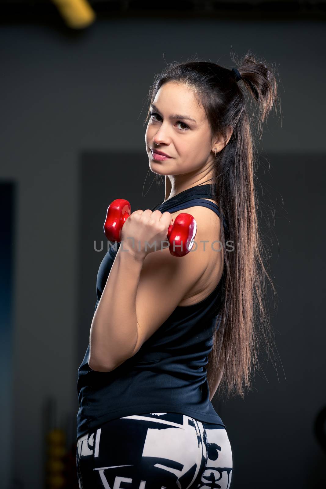 beautiful woman with dumbbells in the gym vertical portrait clos by kosmsos111