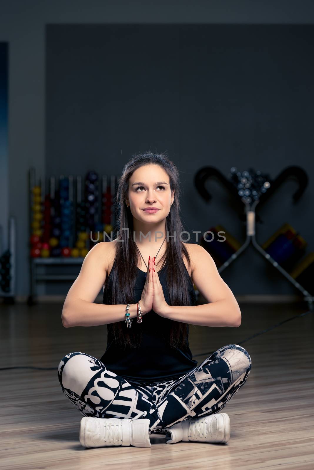 beautiful brunette doing yoga in the gym, simple asanas