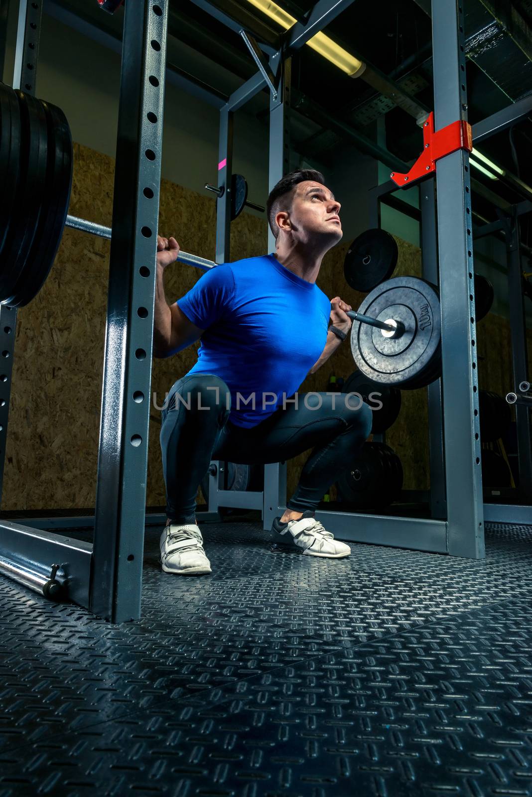 athlete with a barbell in the gym, dark photo by kosmsos111