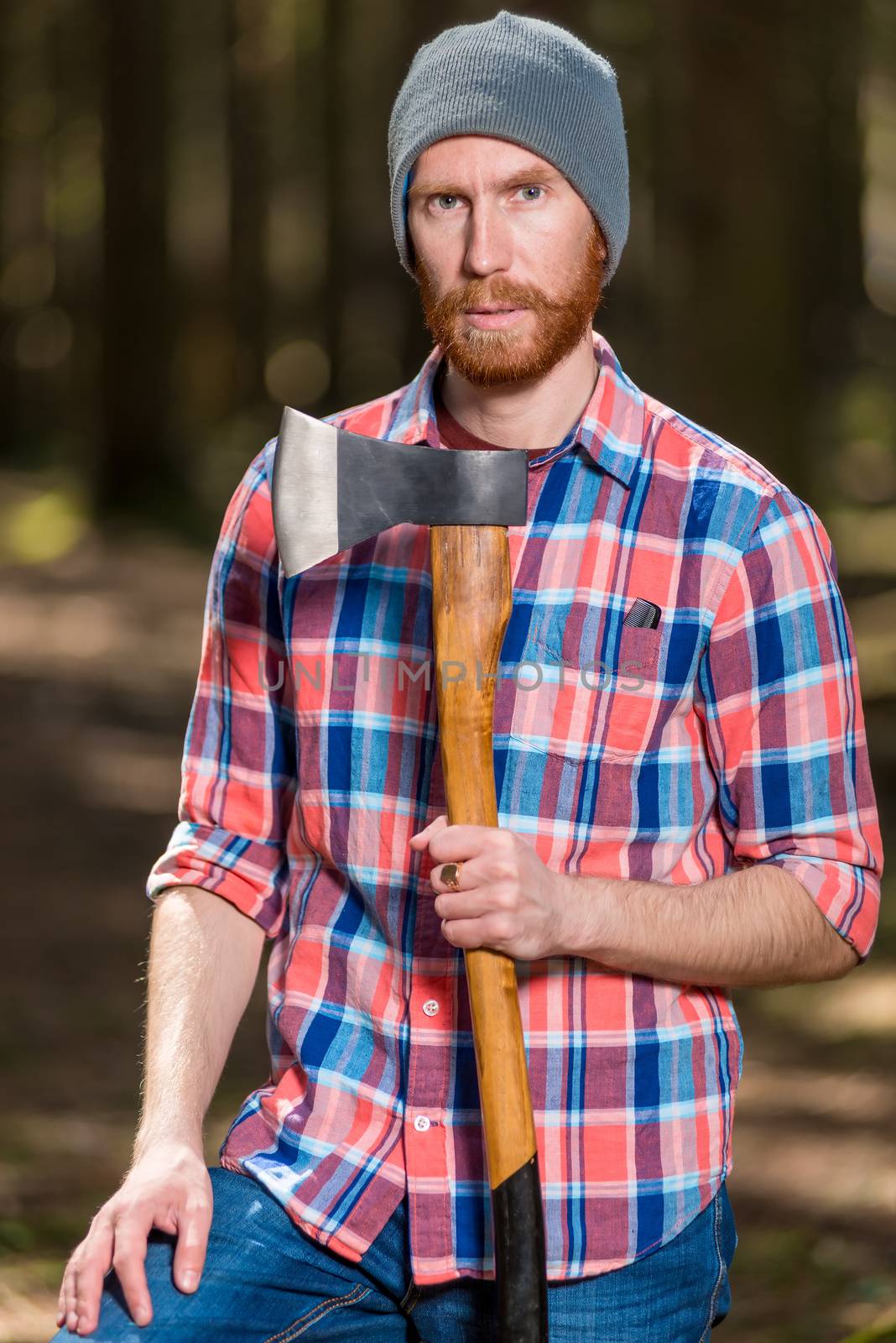 a forester with a red beard posing in a forest with an ax by kosmsos111