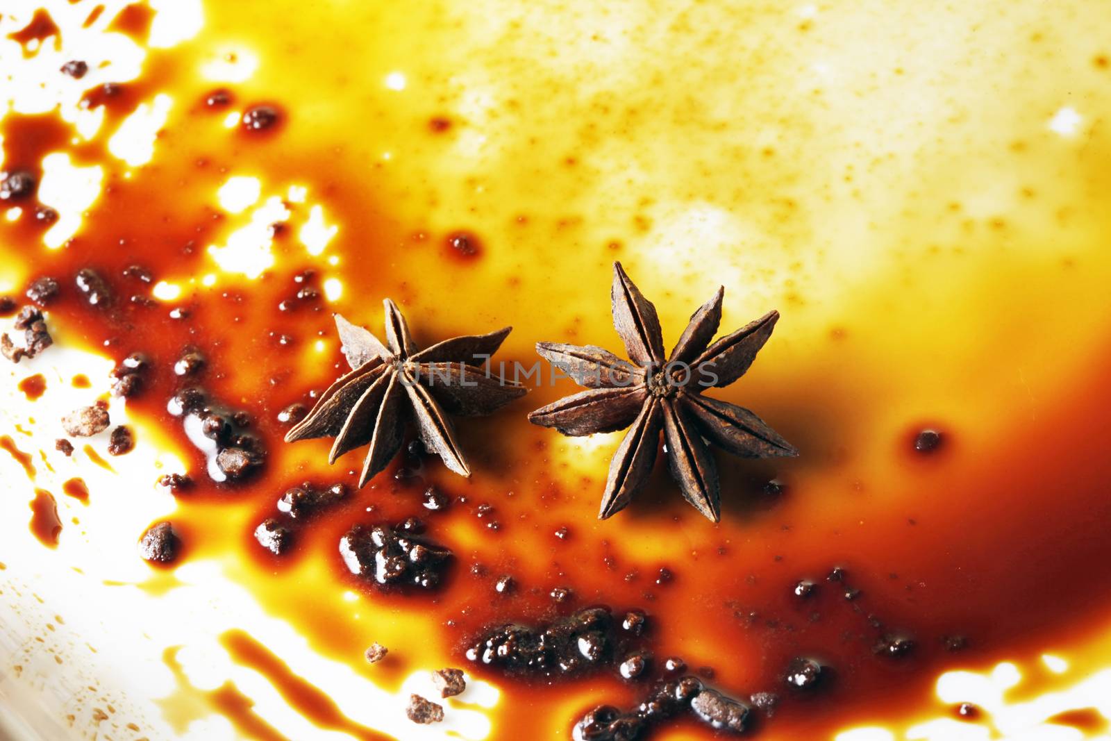 Asterisks anise on a plate with chocolate sauce by friday