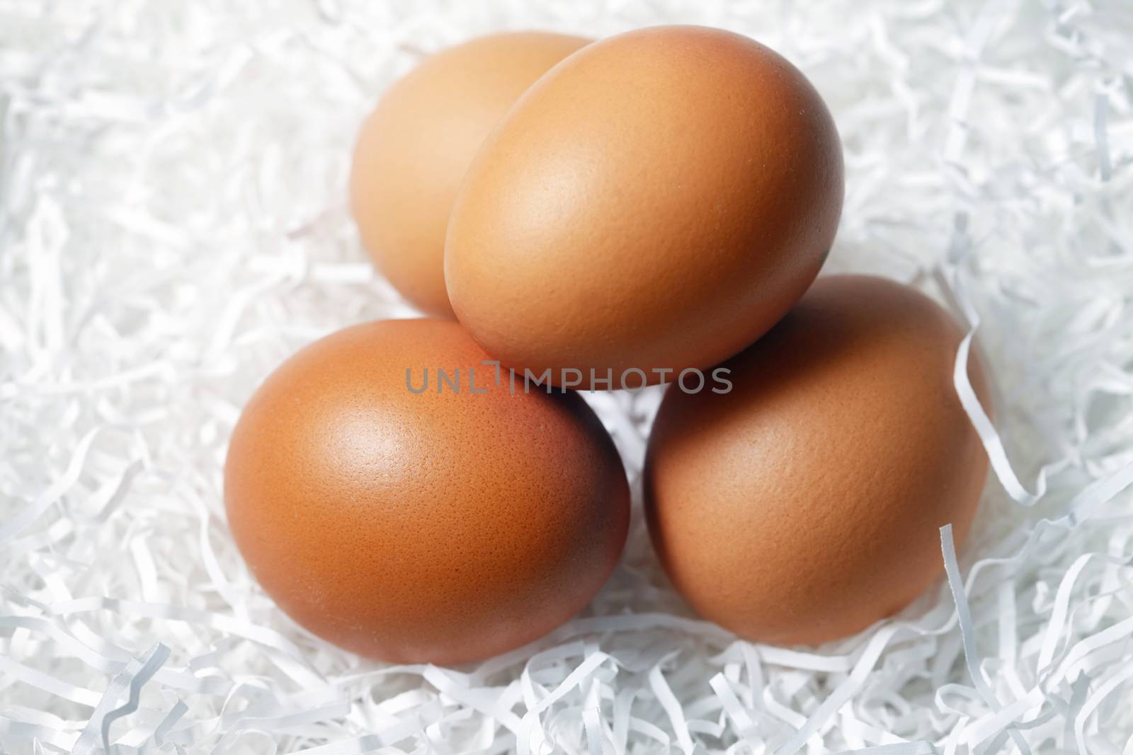 Four brown eggs fresh in paper by friday