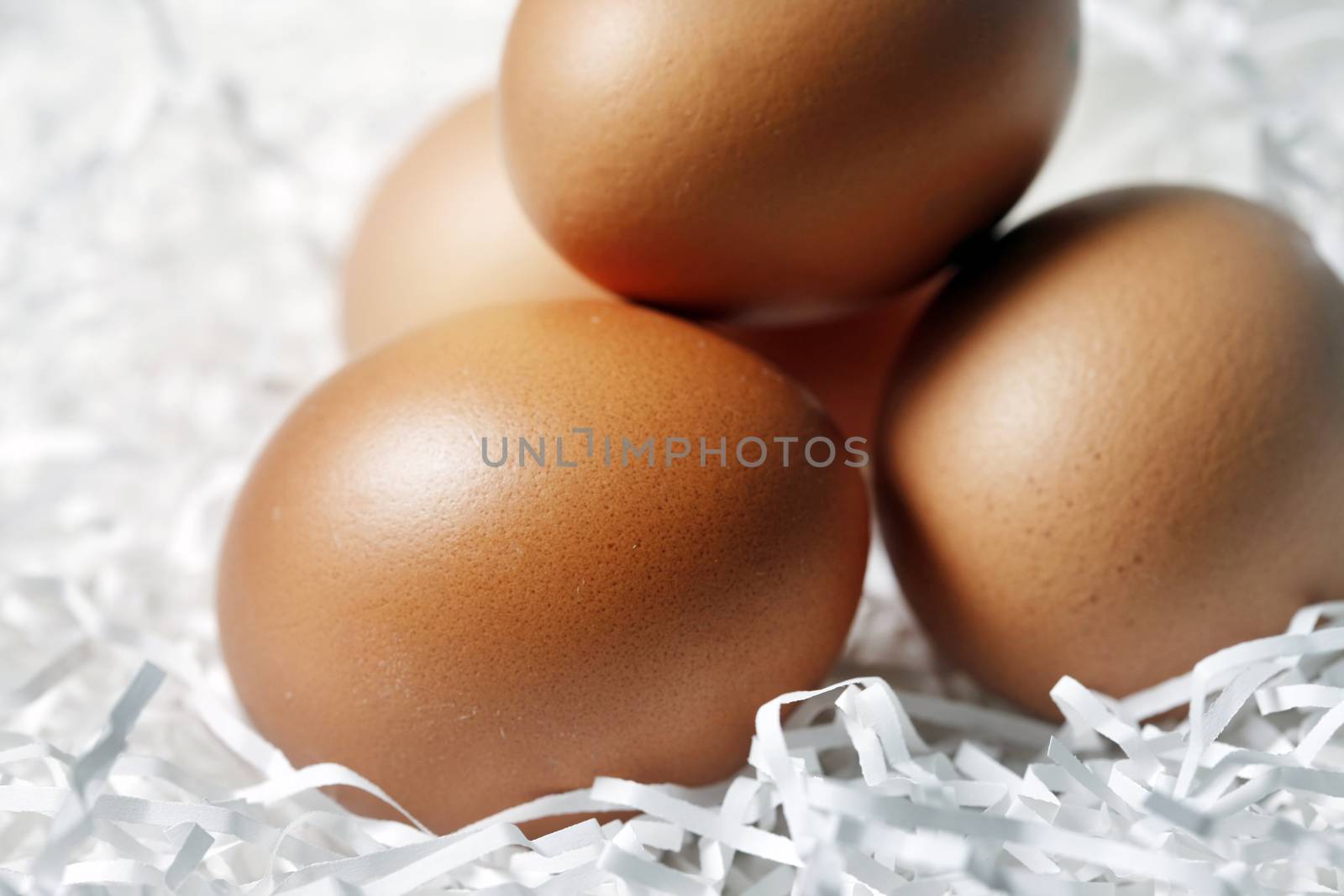 Four brown eggs fresh in paper