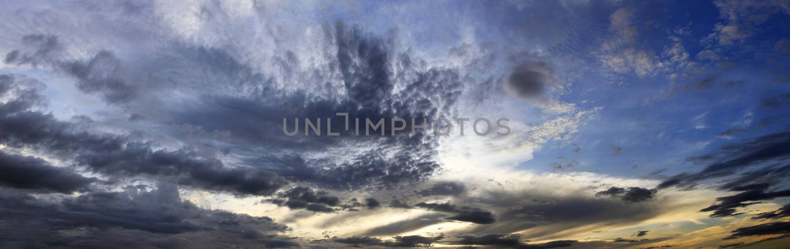 The image of clouds on a background of the dark blue sky