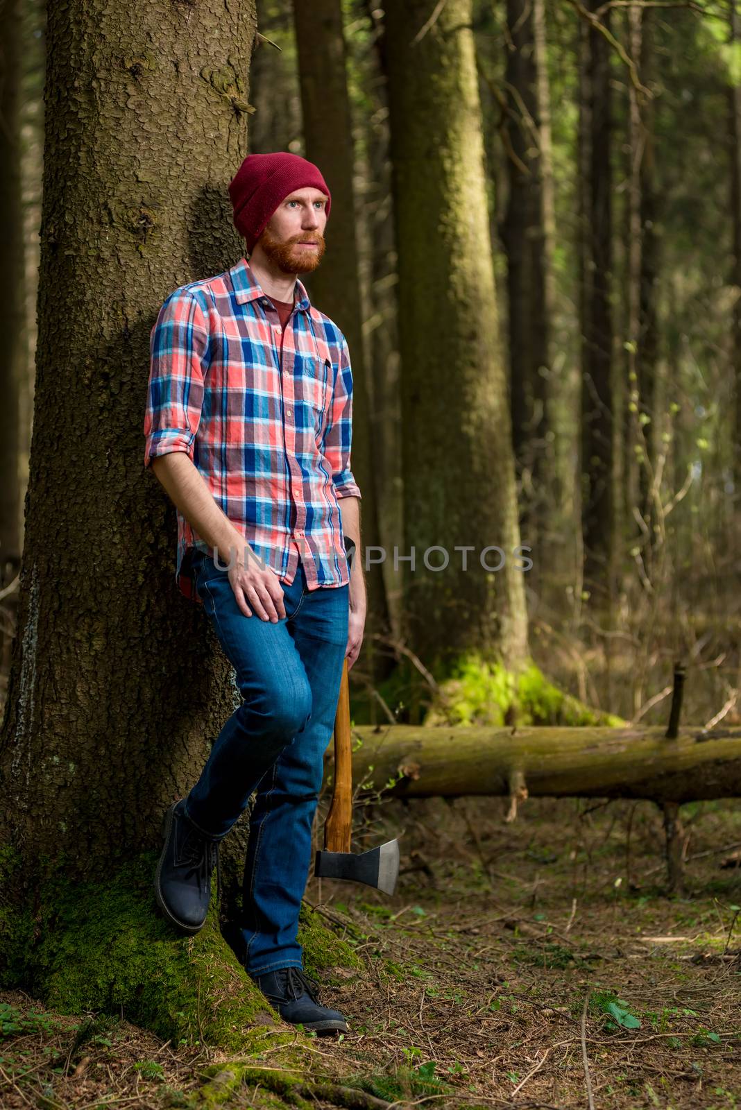shooting a forester with an ax in the forest on a summer day by kosmsos111