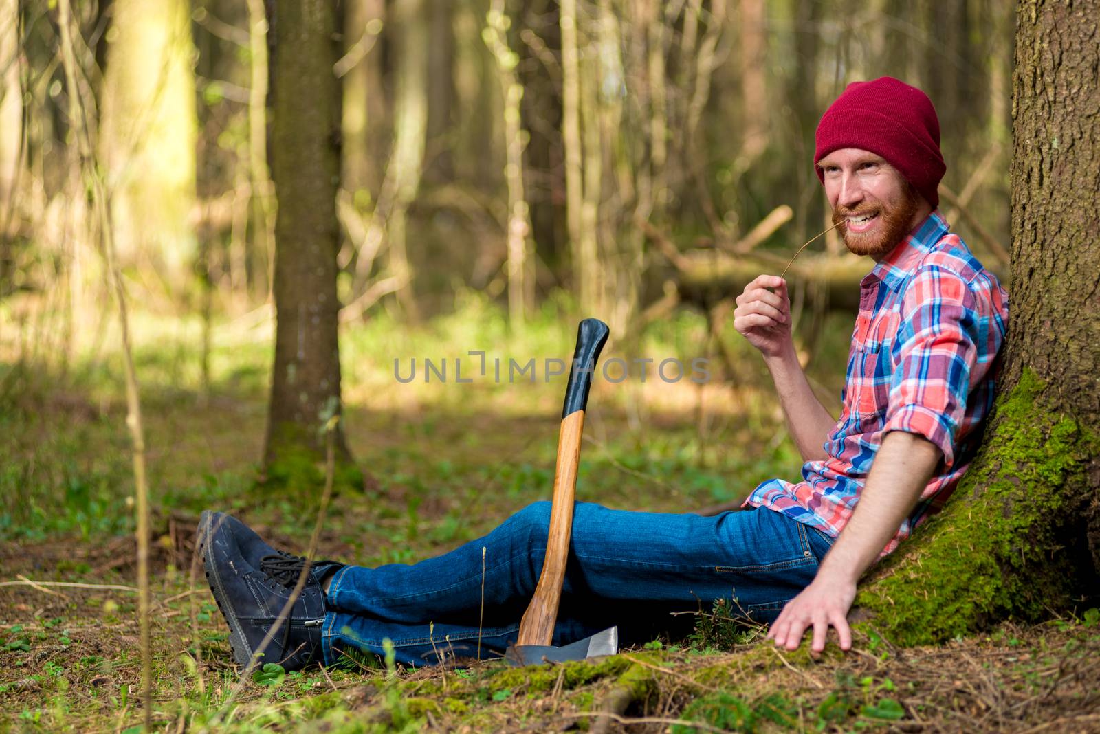 happy woodcutter to rest near a tree in the forest by kosmsos111