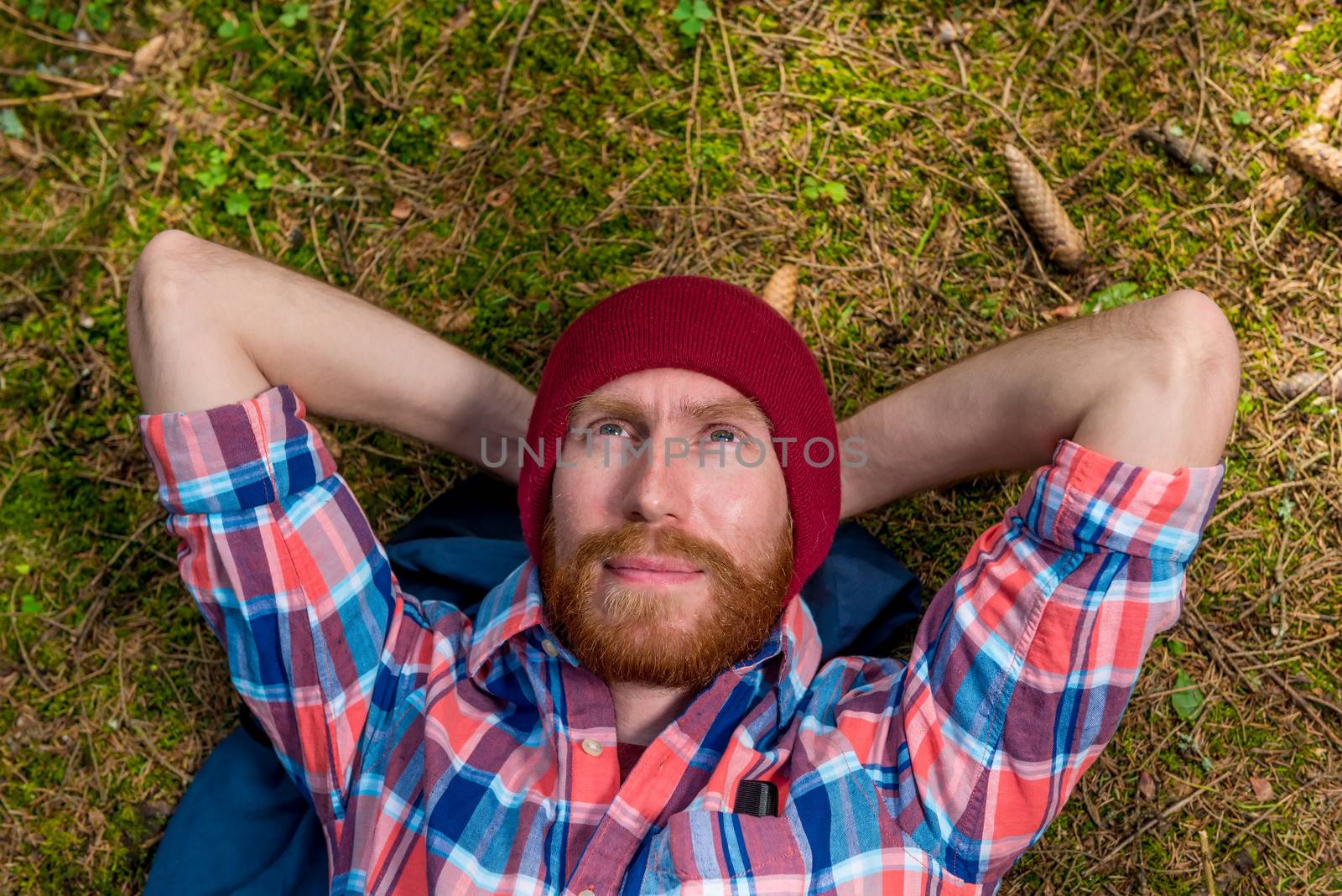 dreamy hipster on the ground in the woods resting and looking at the sky