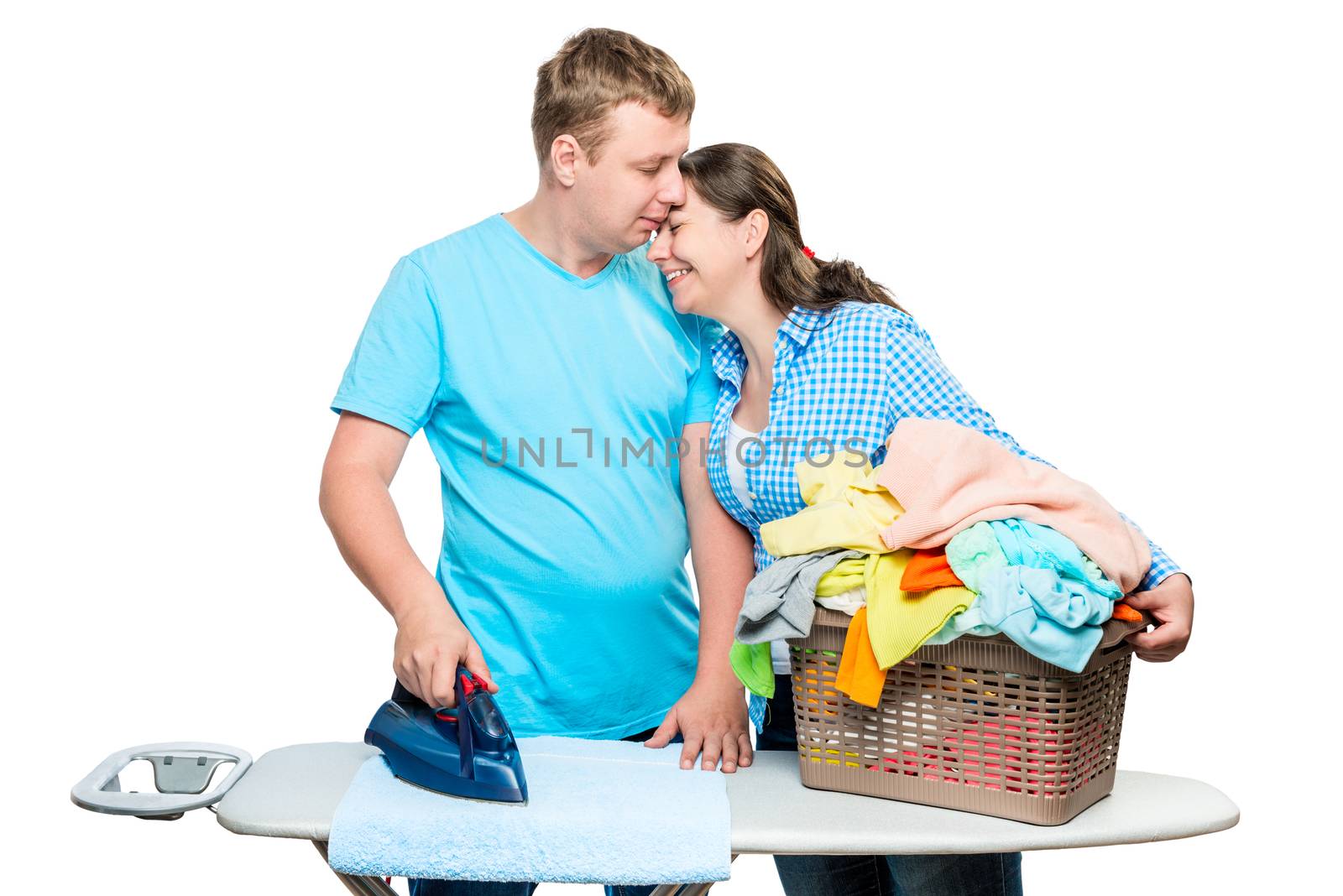 the husband helps his wife to iron clothes, help around the house, the portrait is isolated