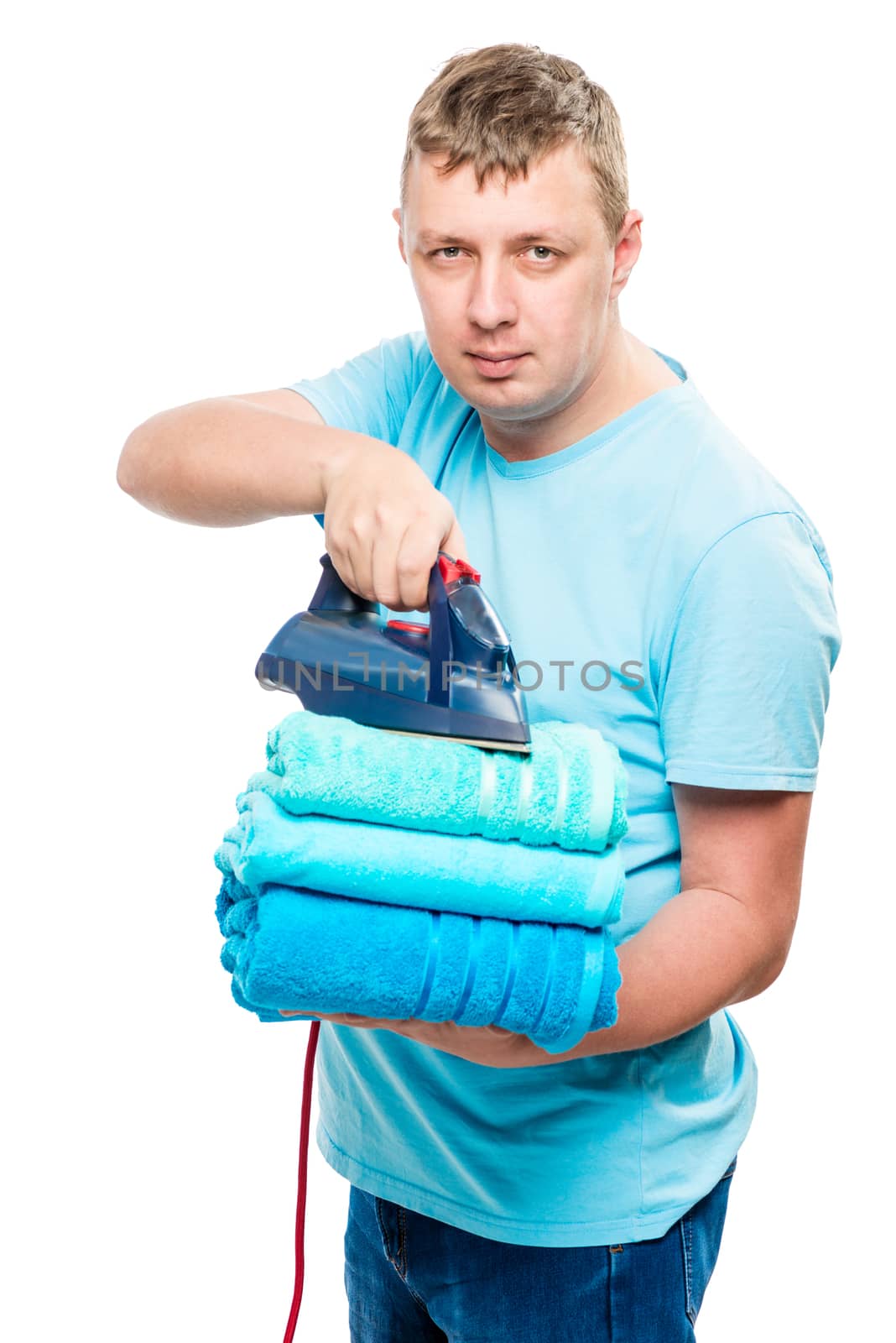 portrait man with iron and a pile of ironed towels isolated by kosmsos111